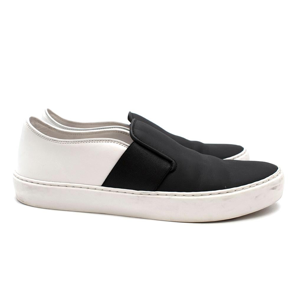 Chanel Black & White Slip-on Sneakers

-Luxurious matte black leather to the front 
-Chanel CC logo to the back 
-Padded leather insoles for extra comfort 
-Elasticated sides for practicality 
-Rubber trim for a great style 
-Branded rubber and