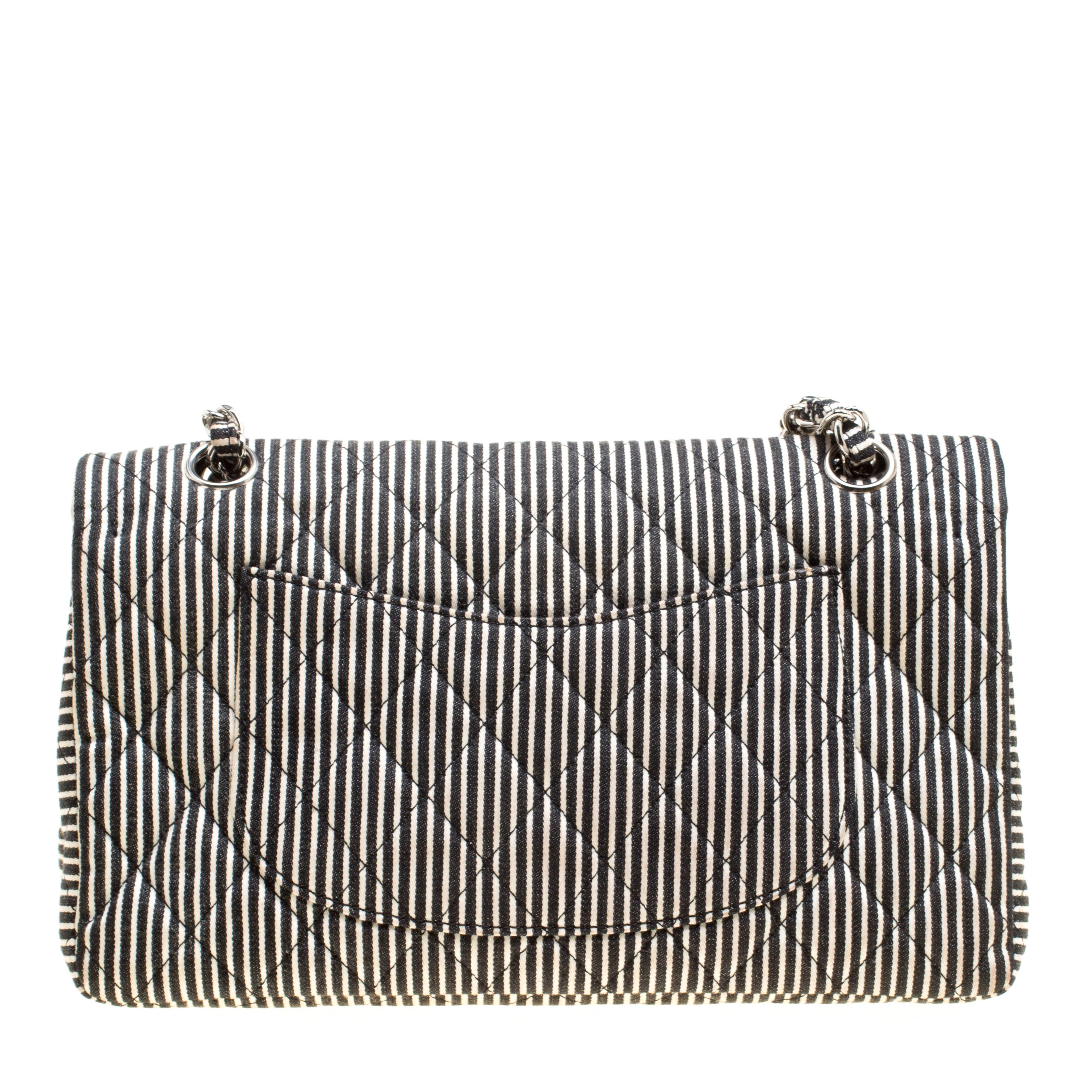 Chanel's Flap bags are the most iconic handbags. This rare and eye-catching piece is from their 2008 Cruise collection. This classic double flap bag is crafted from black and white stripe fabric along with intricate sequin detailing on the front