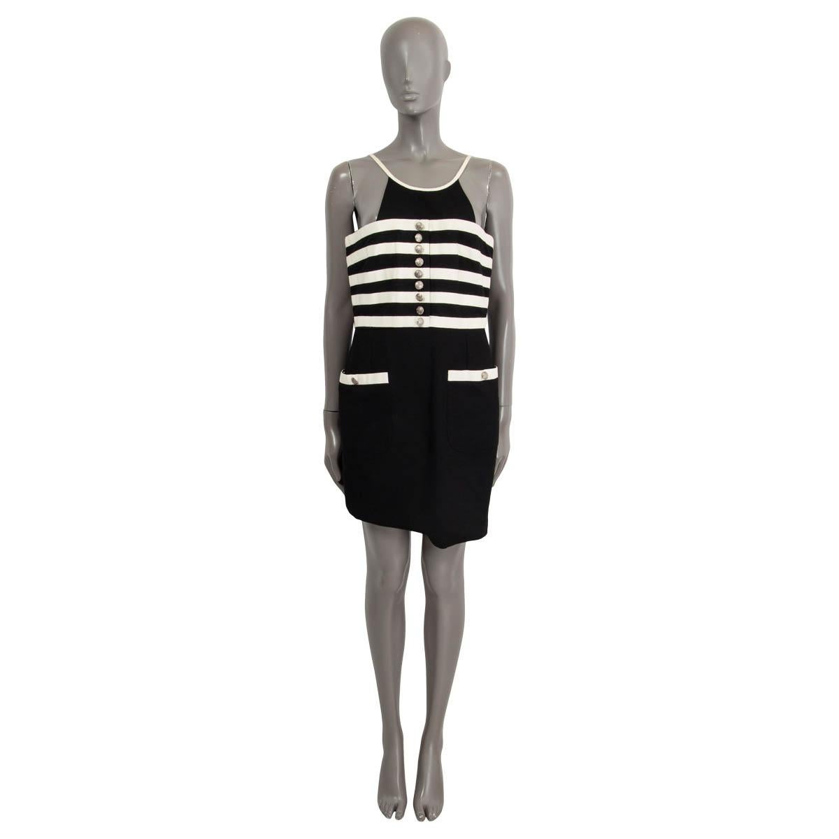 100% authentic Chanel striped halter neck mini dress in black and white cotton (assumed cause tag is missing). Features two buttoned patch pockets on the front and faux buttons on the bust. Opens with a zipper and a hook on the back. Lined in black