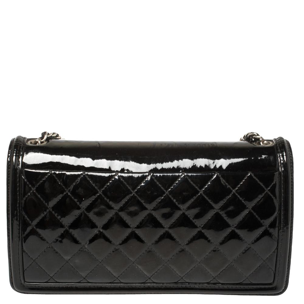 The Chanel Boy Brick bag comes as an interesting update of the Boy flap bag. Designed in similarity with Chanel's Lego clutch, the bag has a plexiglass panel on the flap detailed with the CC logo. The patent leather bag has quilting on the back and