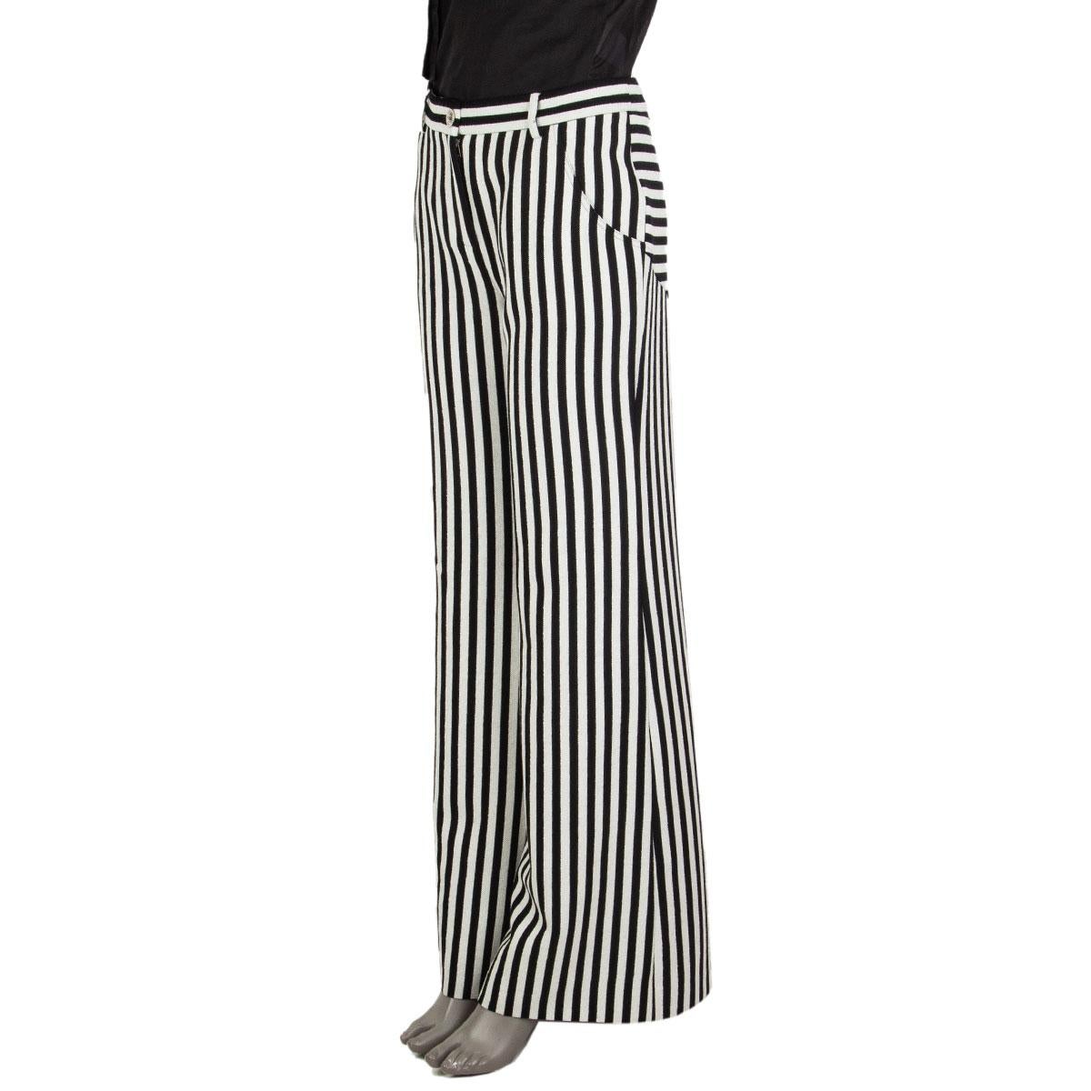 These 100% authentic Chanel pants in black and white striped textured wool (72%), polyamide (20%), and viscose (8%) offer a sophisticated take on timeless style. Featuring a wide-leg silhouette and two slant pockets, they combine comfort with