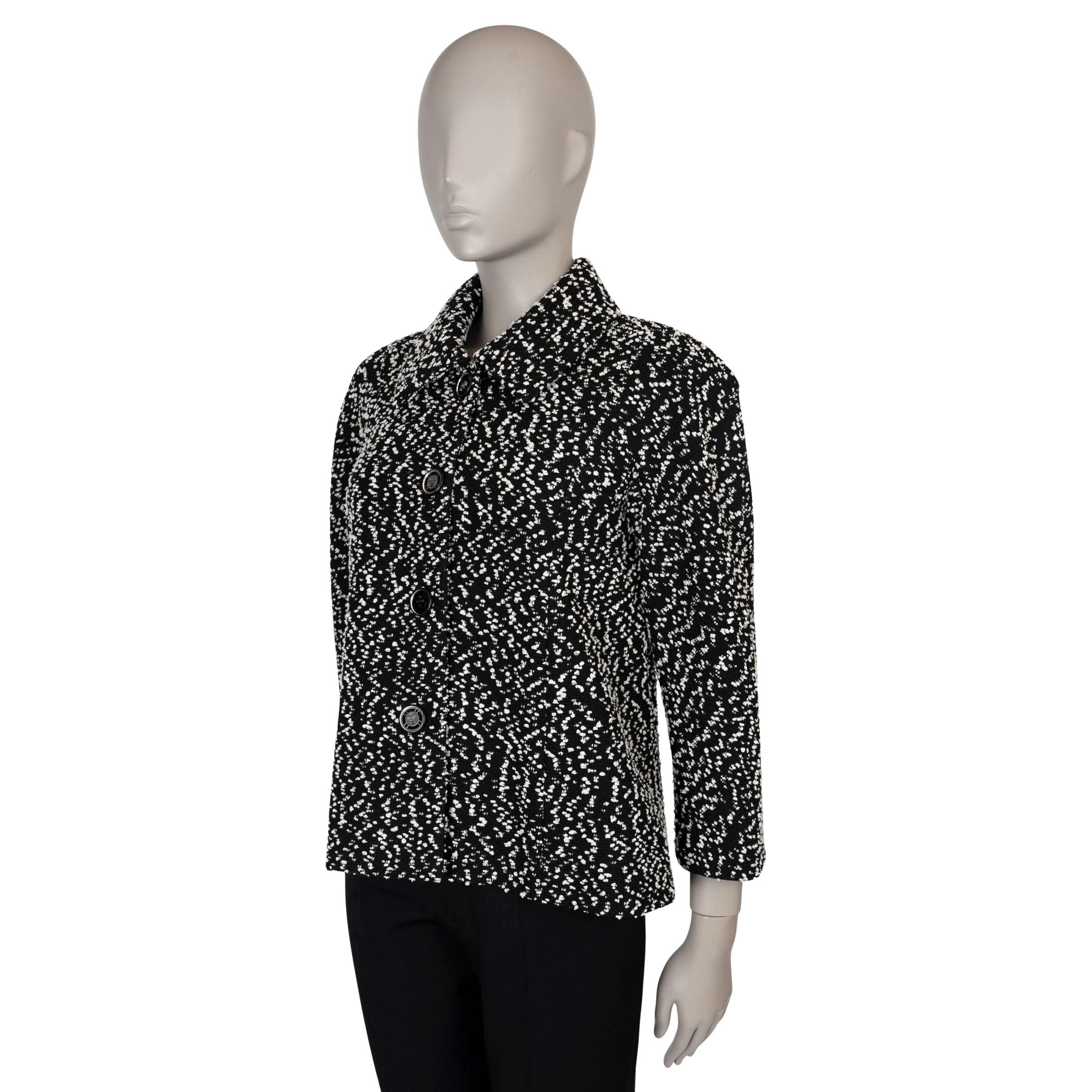 This 100% authentic Chanel La Pausa jacket in black and white tweed is a timeless piece, crafted with a stylish trapeze cut, softly padded shoulders and 3/4 raglan sleeves for a sophisticated, relaxed fit. Adorned with iconic 
