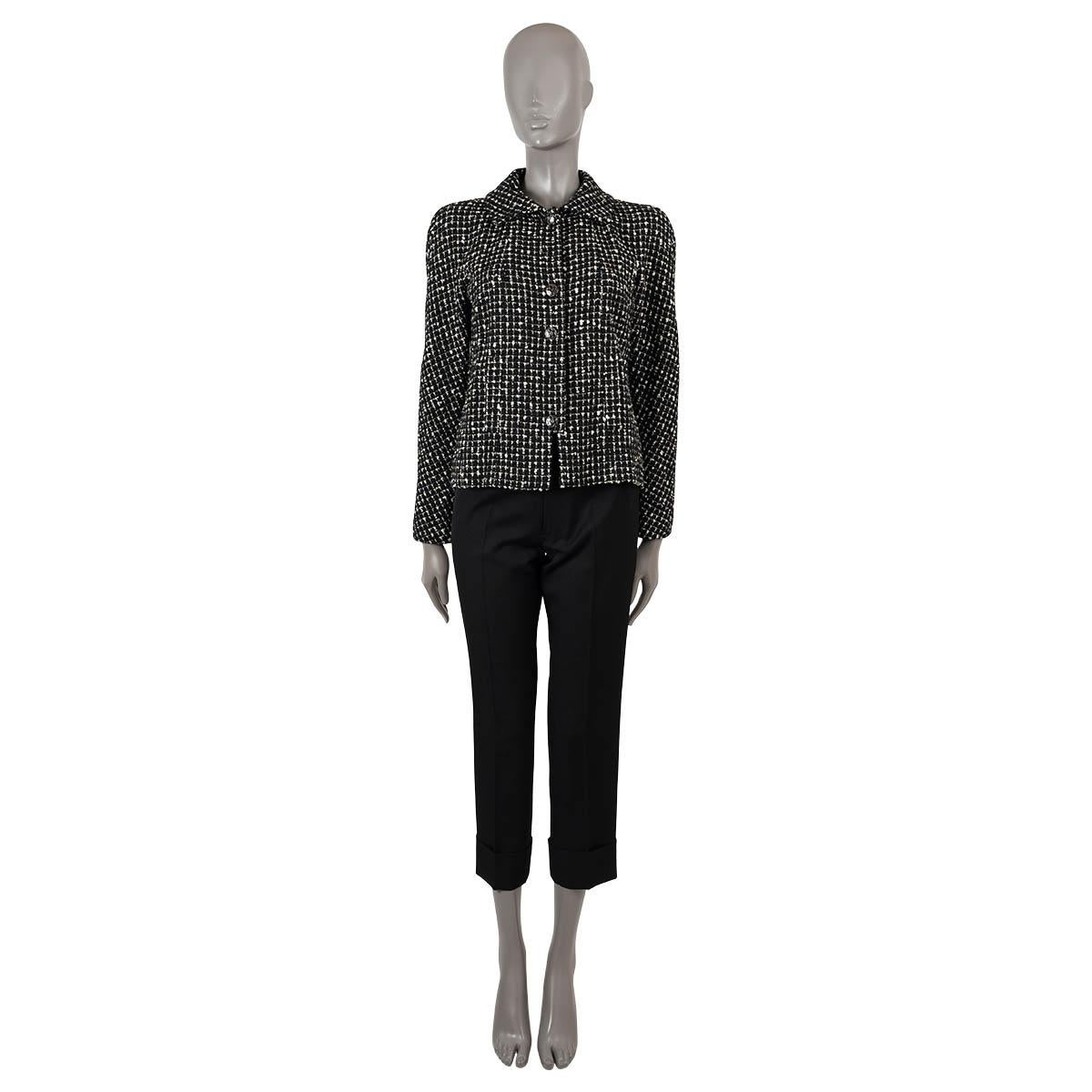100% authentic Chanel tweed jacket in black and white wool (68%), polyester (21%) and nylon (11%). Features a pointed collar and two slant pockets at the waist. Closes with black enamel CC buttons on the front and is lined in silk (100%). Has been