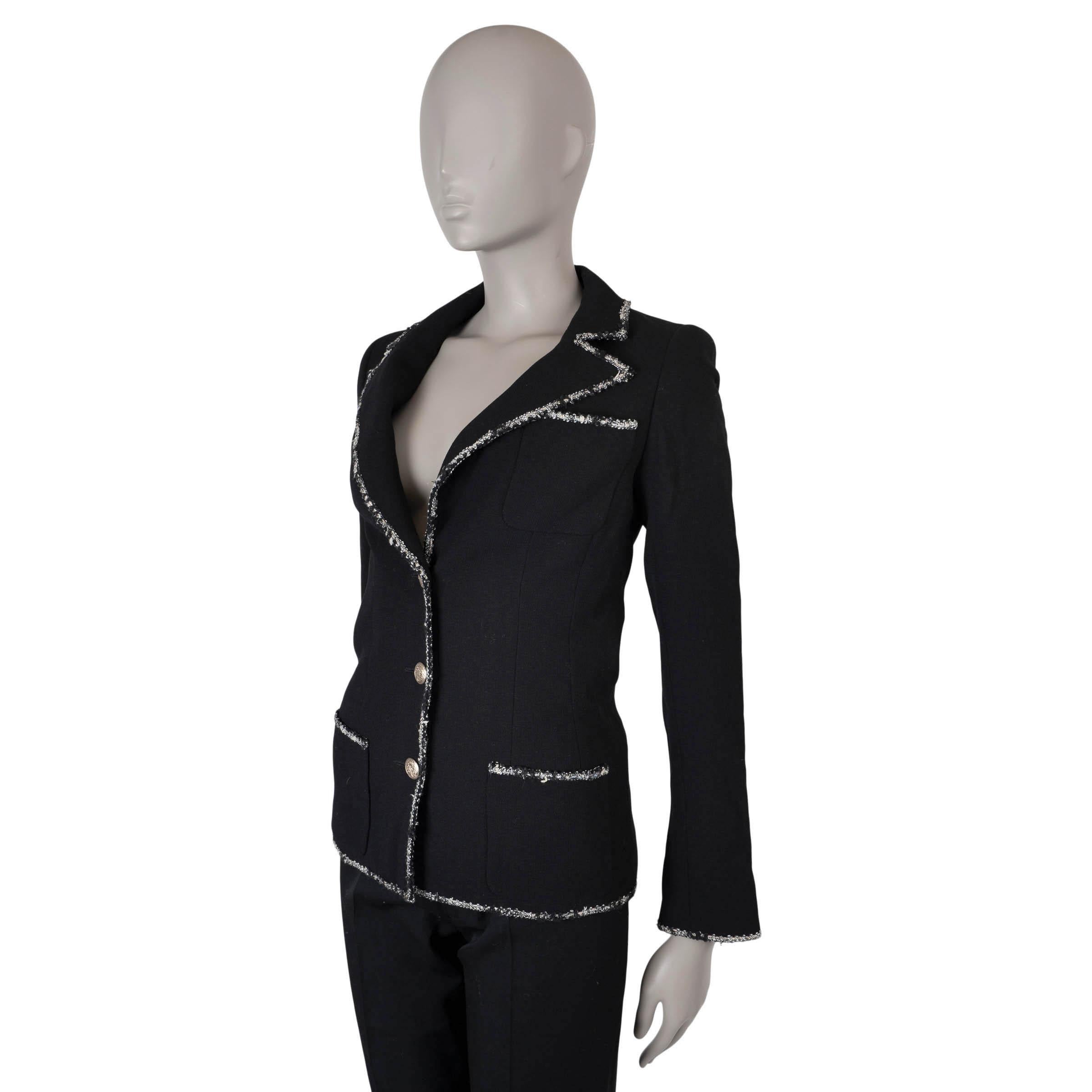  This 100% authentic Chanel Collage blazer in black wool is a true icon, as seen on Anne Hathaway in The Devil Wears Prada. It features a fitted silhouette with peak lapels and is accented with silver lurex tweed trims for added elegance. The blazer