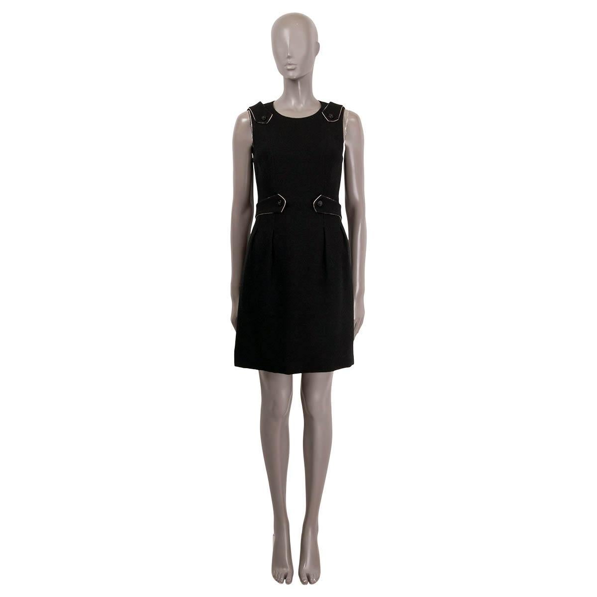 100% authentic Chanel 2006 Fall/Winter sleeveless dress in black wool (100%). Featuring belt straps at the waist and shoulders with crystal embellished cross buttons and box pleats at front. Opens with a zipper in the back and is lined in silk