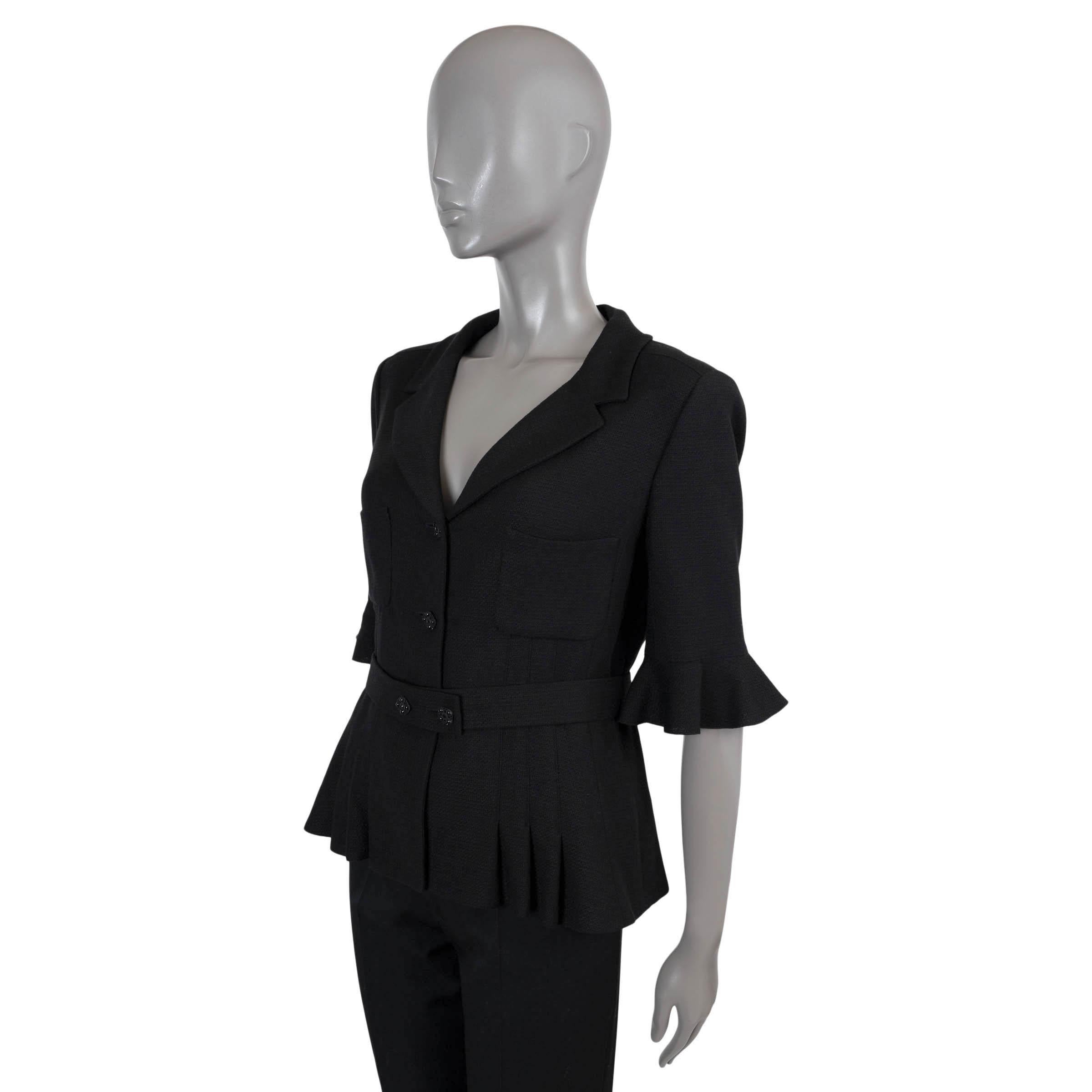 100% authentic Chanel belted 3/4 sleeve flared jacket in black woven wool (53%), silk (31%) and viscose (16%). The design features a notch lapel, two chest patch pockets, three crystal stone embellished buttons, ruffle details on the sleeve and a
