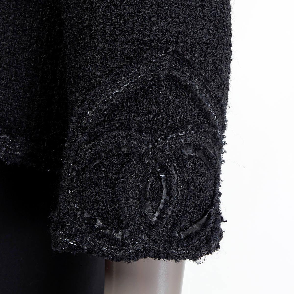 100% authentic Chanel Cruise 2009 fantasy tweed jacket in black wool (99%) and nylon (1%). Features 'CC' hearts at the cuffs and two sewn shut slit pockets on the front. Has a signature weight chain around the inside of the hemline. Opens with one