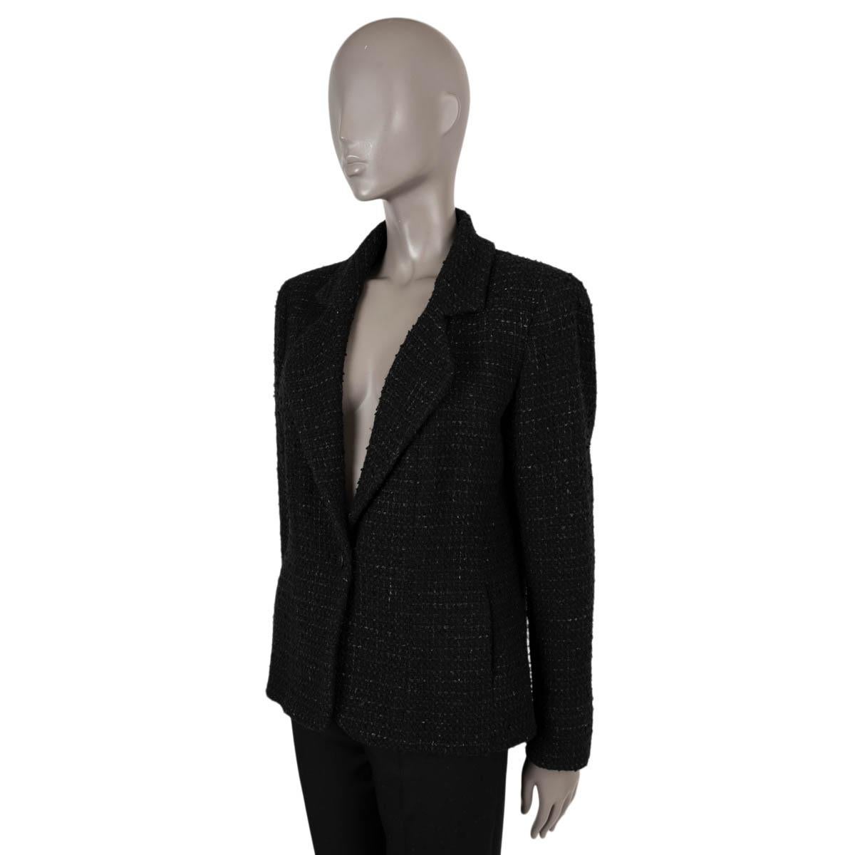 100% authentic Chanel classic one-button tweed jacket in black melange wool (86%), polyamide (10%) and polyester (4%). The design features one CC front button, two buttons on each cuff and two slit pockets on the side. Lined in black silk (100%).