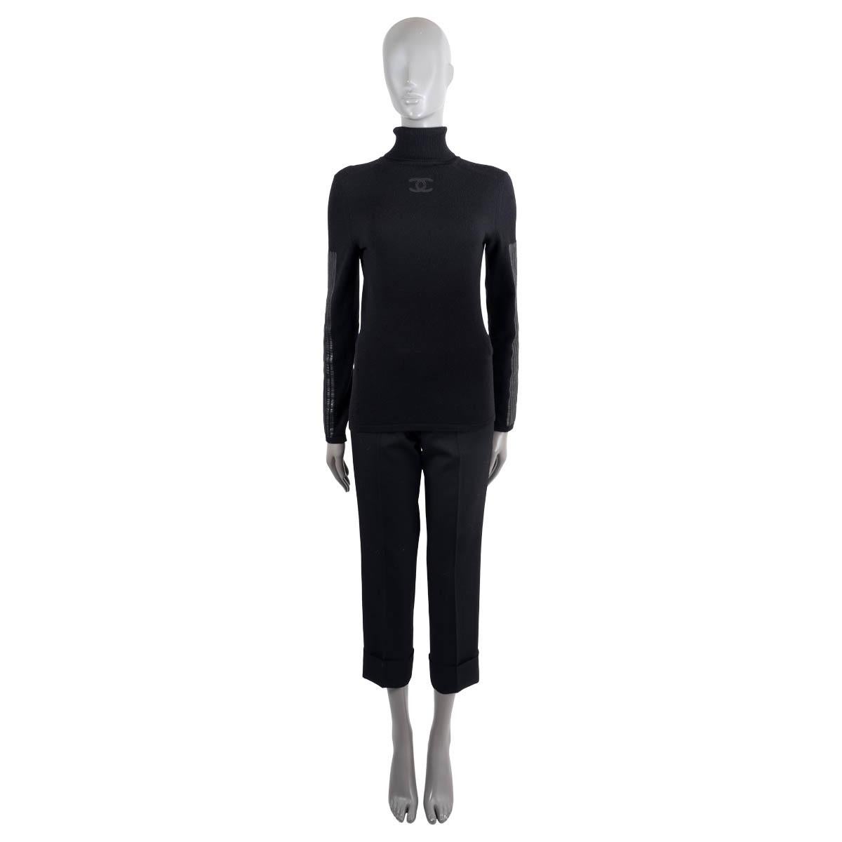100% authentic Chanel turtleneck sweater in black wool (70%) and cashmere (30%). Features black leather stripes on the sleeves and leather CC on the neck. Has been worn and is in excellent condition. Please note the Chanel label has been removed,