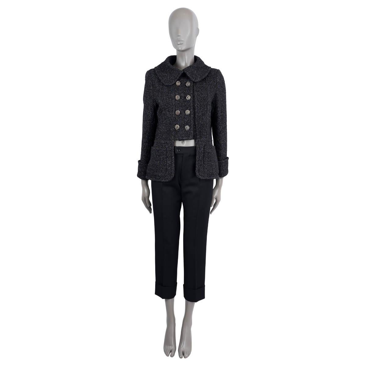 100% authentic Chanel double-breasted peter pan-collar tweed jacket in midnight blue and black polyamide (50%), wool (40%) and polyester (10%). Lined in black silk (100%). The design features a cut-out detail at front, a buttoned slit on the back,