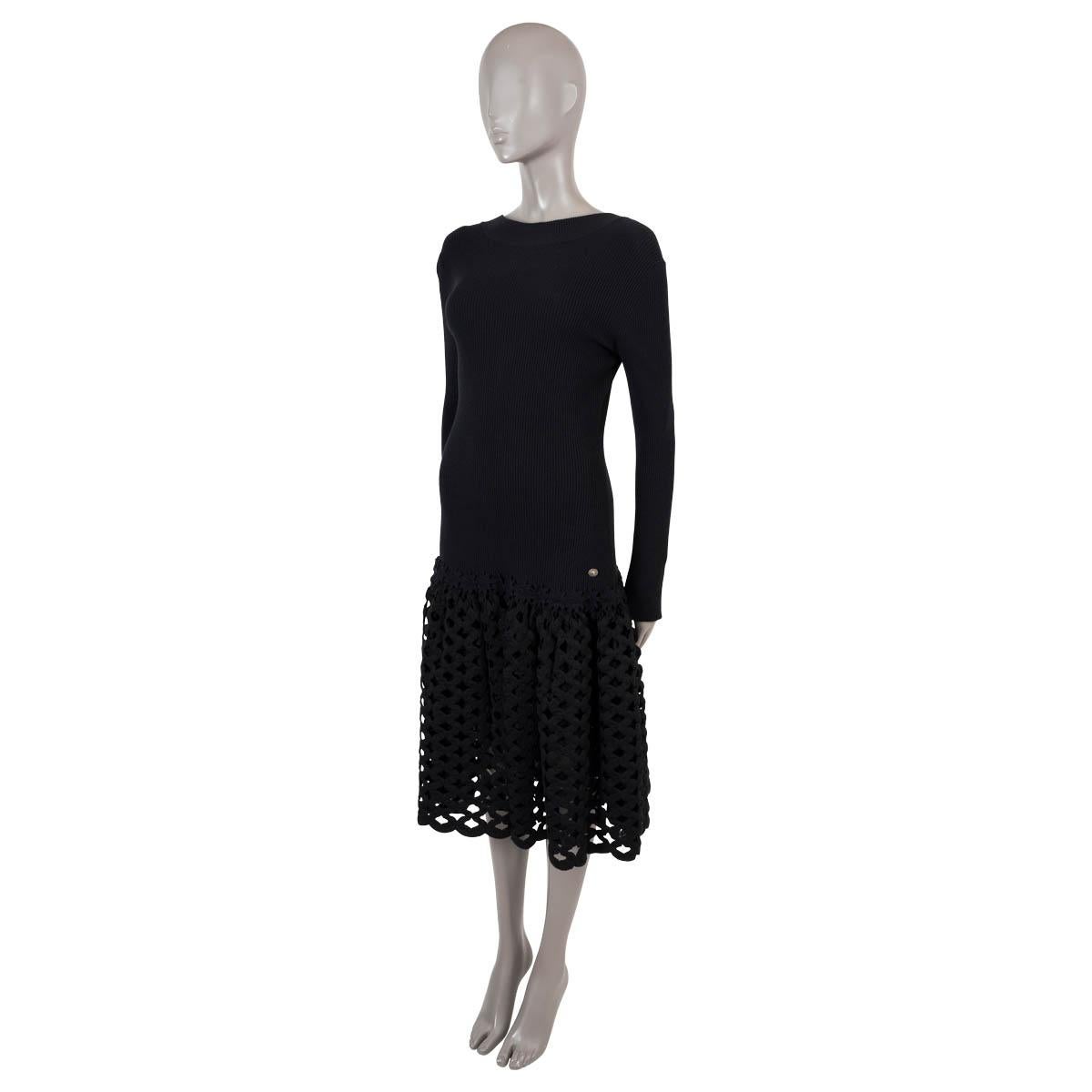 100% authentic Chanel panelled knit dress in black wool (46%), nylon (29%), mohair (16%) and polyester (9%). Features long sleeves, a rib-knit top and lattice skirt, drop waist with floral trim, V cut back and lion head button on the hips. Unlined.