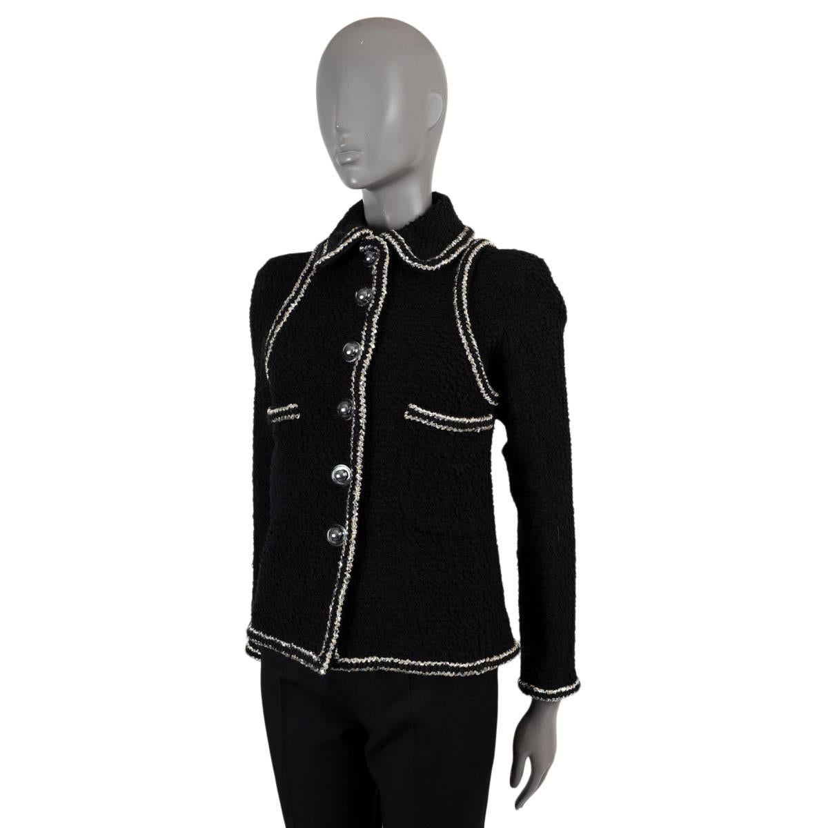 100% authentic Chanel tweeded gauze jacket in black wool (70%), nlyon (18%) and silk (12%). Features contrasting trims in silver and two patch pockets. Closes with clear cabochon buttons with black CC pearl on the inside and is lined in silk (100%).