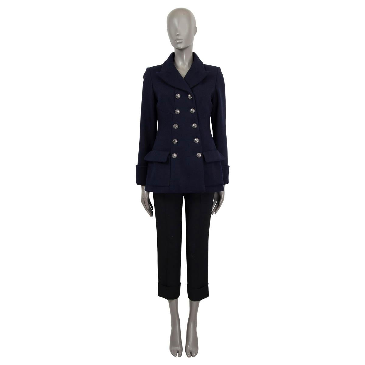 100% authentic Chanel peacoat in navy blue wool (100%). Features a back belt, two front flap pockets and folded cuffs. Opens with anchor embellished gunmetal buttons. Lined in navy blue silk (100%). Has been worn and is in excellent condition.