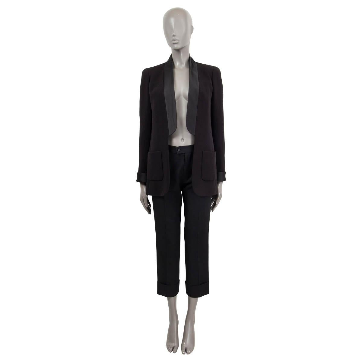 100% authentic Chanel open tuxedo blazer in black wool (100%) with satin shawl collar. Features two patch pockets on the front and satin cuffs with black CC buttons. Lined in silk (100%). Has been worn and is in excellent condition.

2018