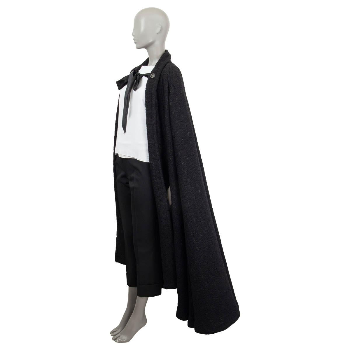 100% authentic Chanel Winter 2019 cape in black bouclé wool (94%), polyester metal (4%) and polyamide (2%) embellished with a black satin bow and two CC logo rhinestone buttons. Has been worn and is in excellent condition.