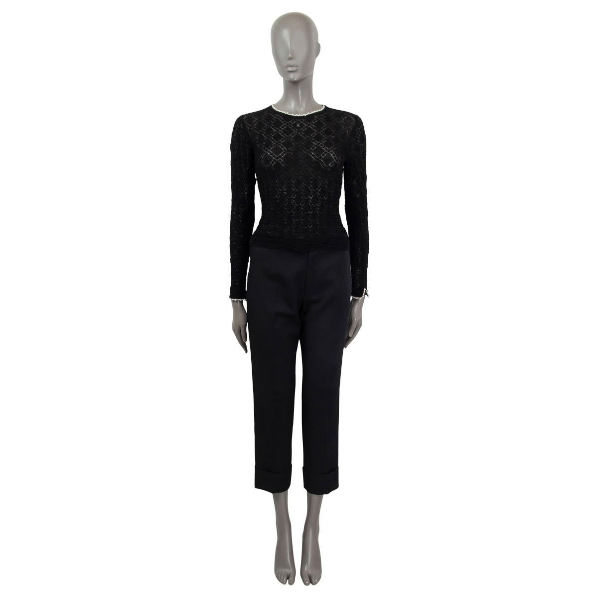 100% authentic Chanel Pre-Fall 2022 semi sheer long sleeve shirt in black virgin wool (100%). Features a faux pearl trim and a crystal 'CC' emblem on the front. Unlined. Has been worn once and is in virtually new