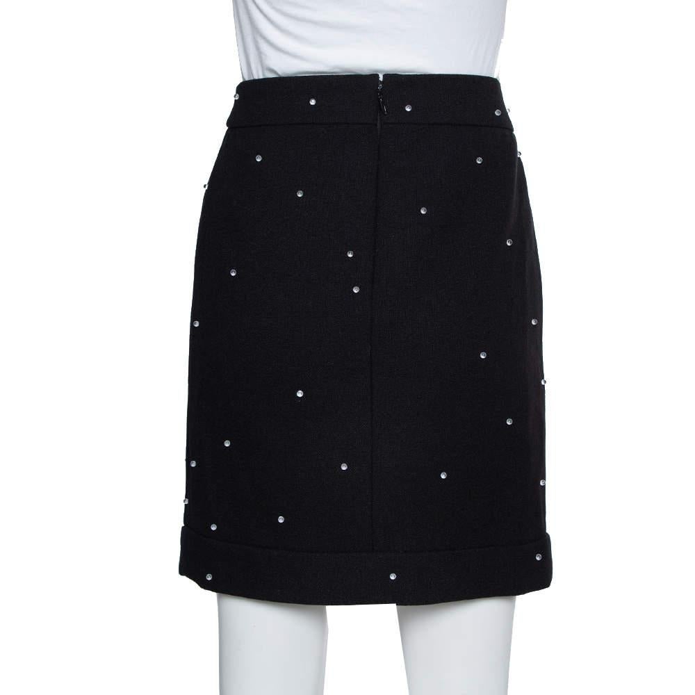 Elegant and modern are two words that pretty much define this Chanel skirt. It is a beautiful black creation cut from quality wool. The skirt is tailored to a fitted silhouette with a short hem and pretty embellishments all over.

