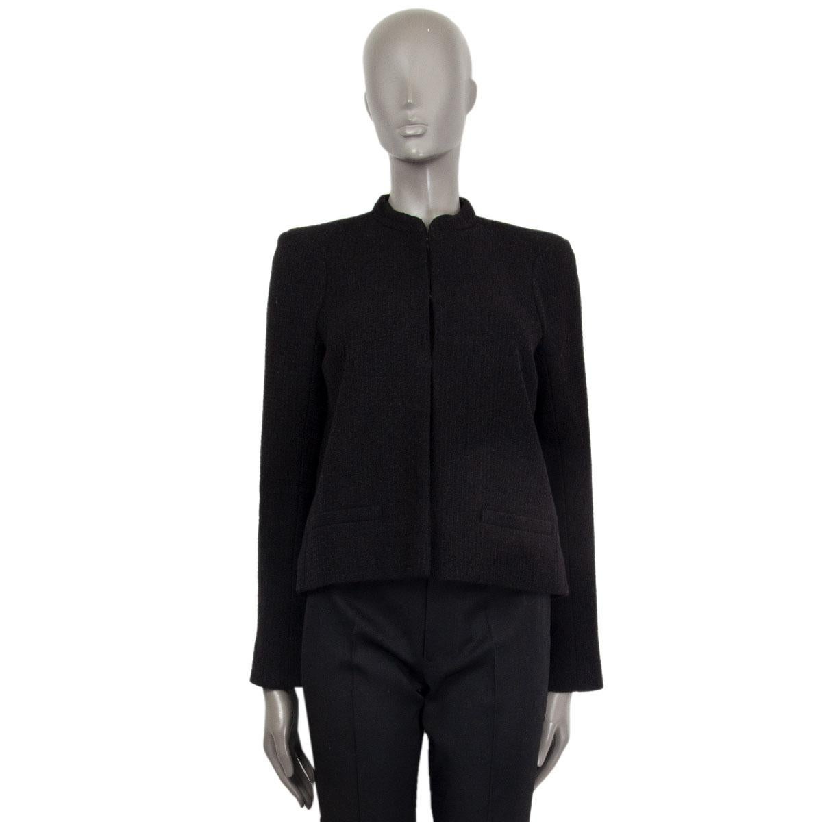 Chanel 2015 Paris-Salzburg jacket in black wool (95%) and nylon (5%) with a mandarin neckline, small front pockets and embossed cuff buttons. Closes on the front with hook fasteners. Lined in silk (100%). Has been worn and is in excellent condition.