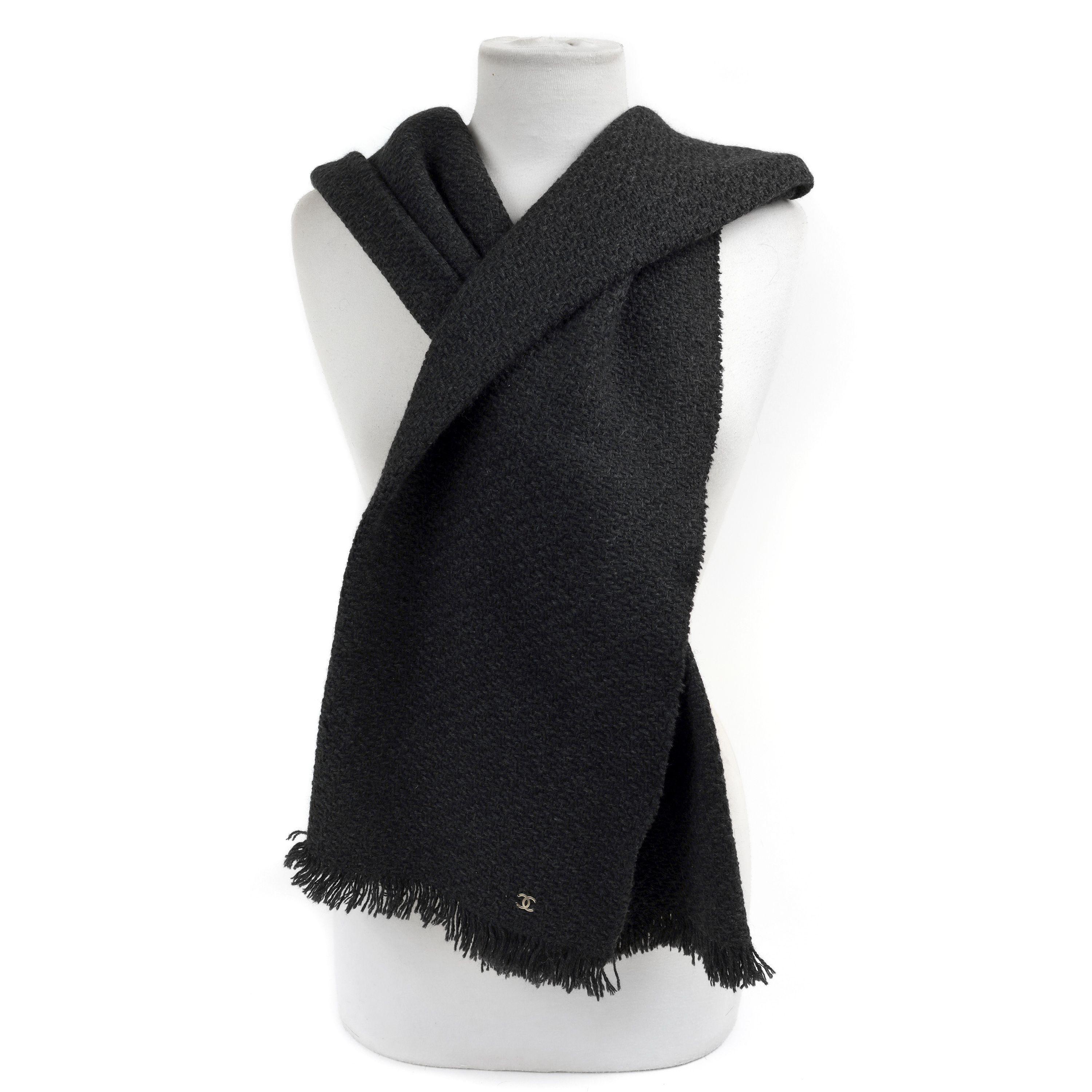 This authentic Chanel Black Wool Blend Scarf is pristine.  Soft black wool blend unisex scarf with fringed edge and CC detail. 

PBF 12638
