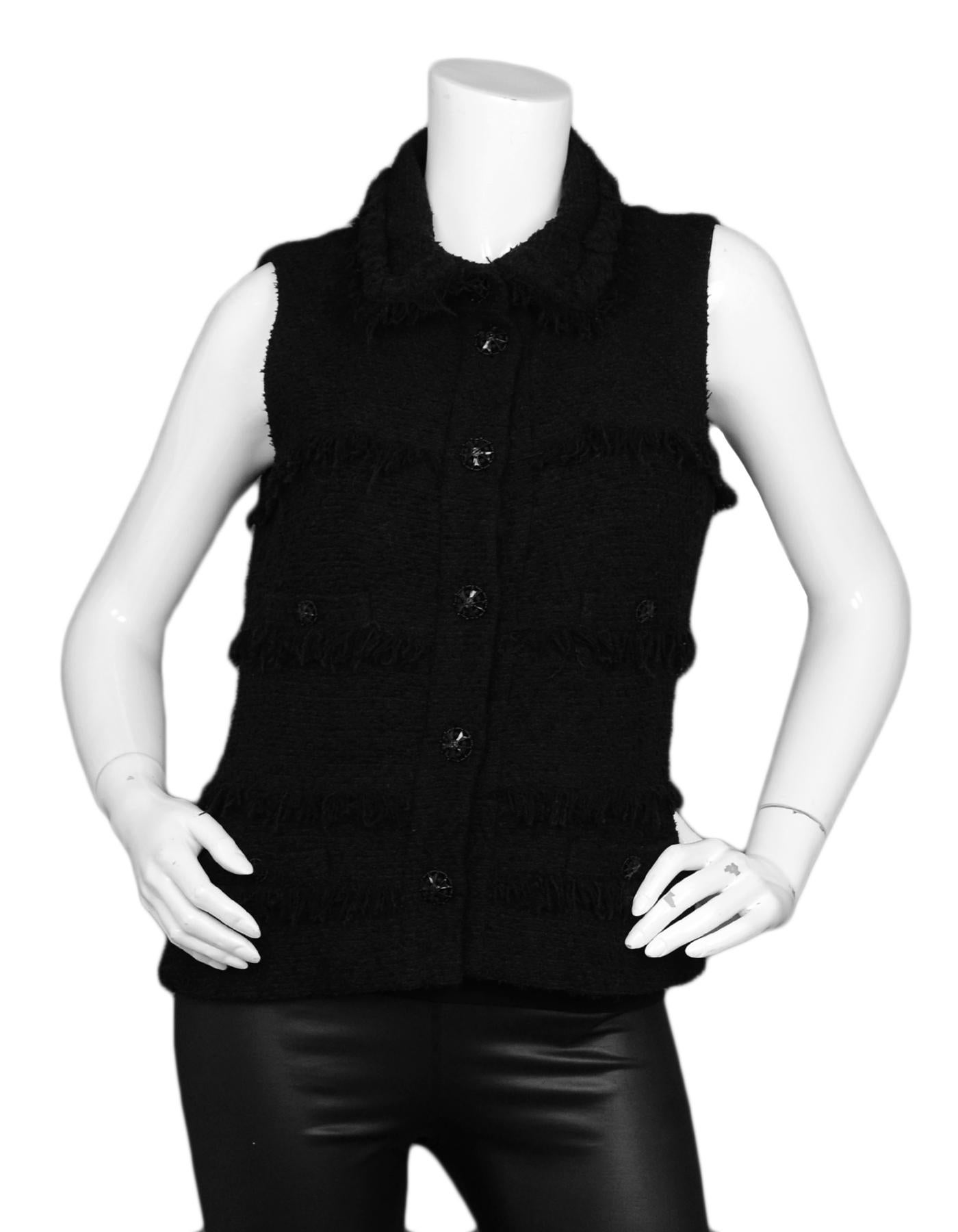 Chanel Black Wool Boucle Vest w/ Fringe sz 38

Made In: France
Year of Production: 2008
Color: Black
Materials: 37% Wool, 32% Silk, 23% Cotton, 8%Nylon
Lining: 86% Silk, 14% Spandex
Opening/Closure: Front buttons
Overall Condition: Excellent