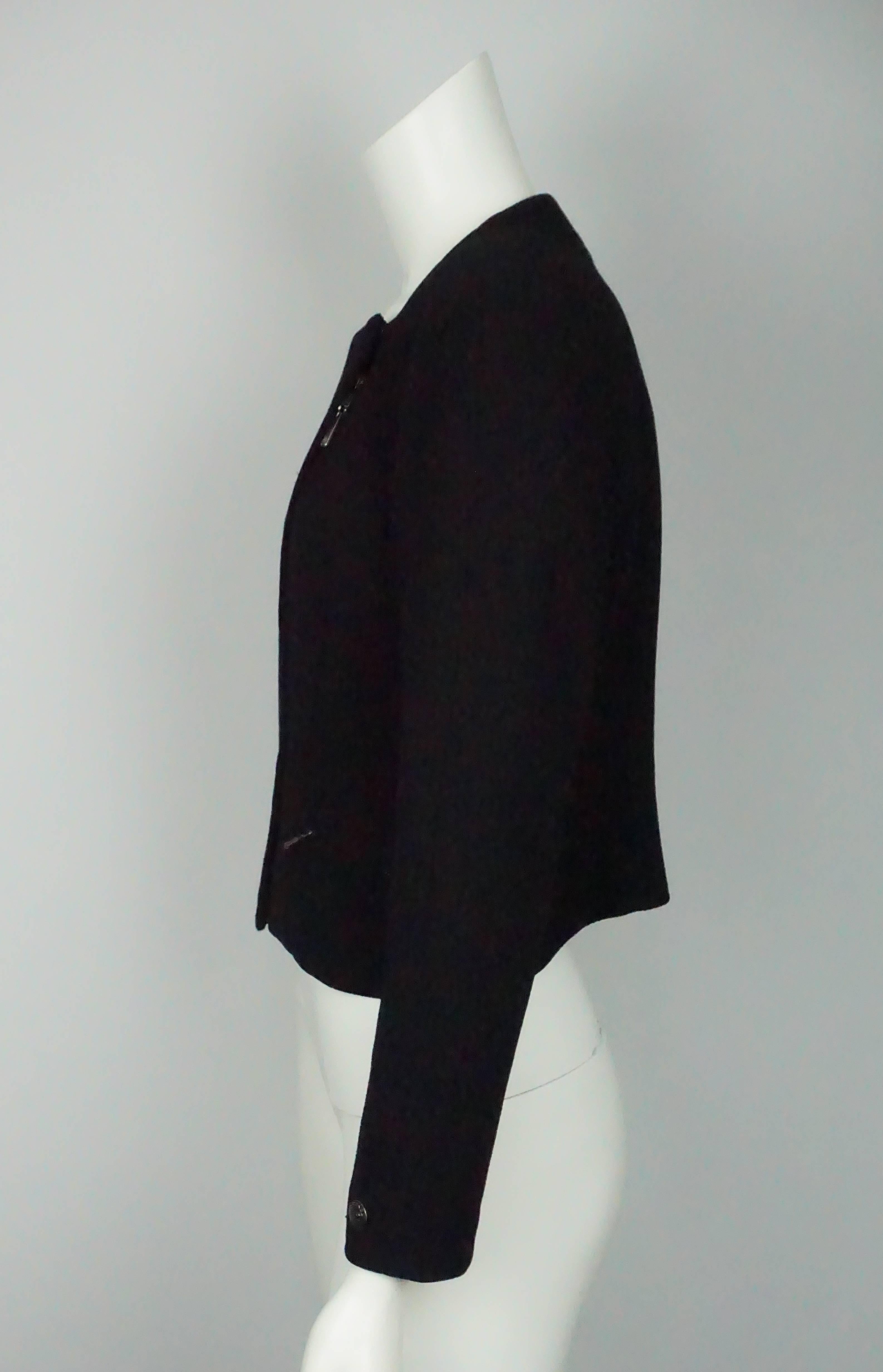 Chanel Black Wool Cropped Jacket w/ Asymmetrical Zipper - 40 - 97A  This timeless Chanel jacket is in excellent condition. The jacket is completely made of wool and is lined in silk with a silver chain on the bottom trim. It has an asymmetrical