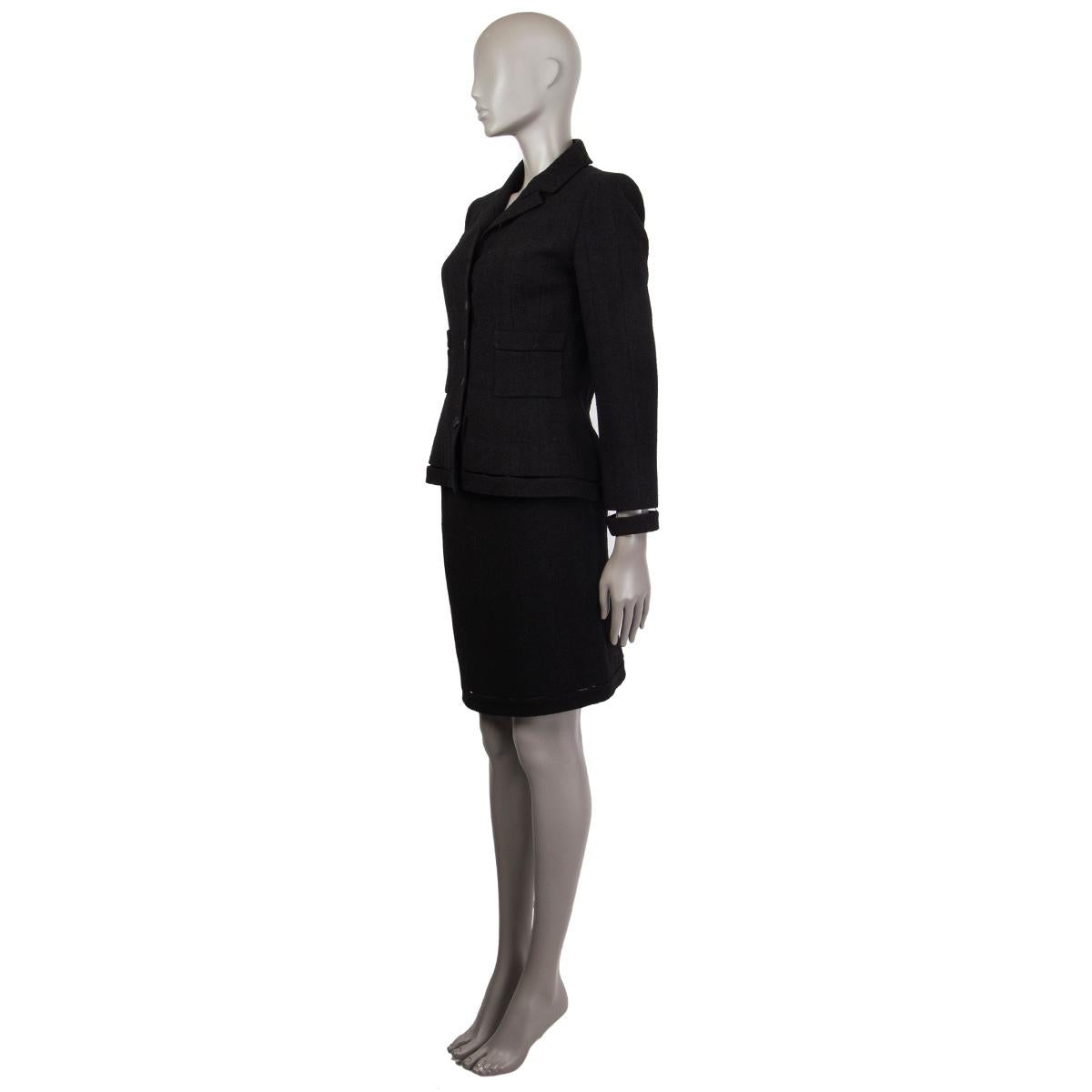 Chanel tweed blazer in black wool (94%) and nylon (6%). With cut-out seams, notch collar, two patch pockets on the front sides, and signature weight chain around the inside of the hemline. Closes with quilt and beaded black buttons on the front.