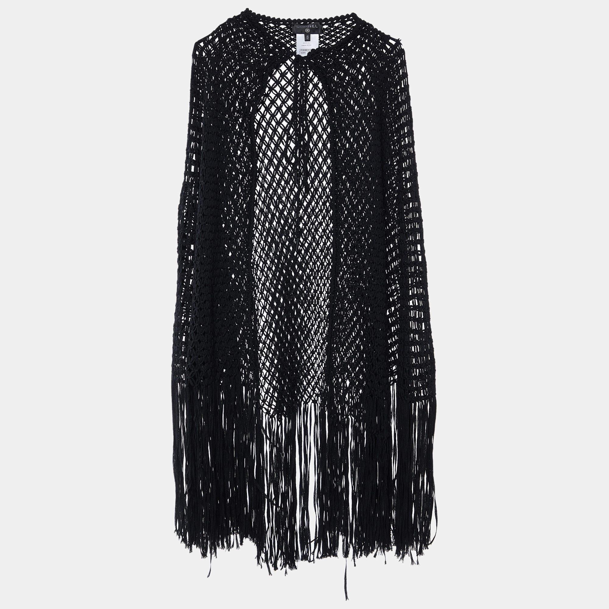 Experience timeless allure with the Chanel cape. Crafted with meticulous attention to detail, this exquisite piece exudes sophistication and refinement. The intricate open braid design and delicate fringe accents add a touch of understated luxury to
