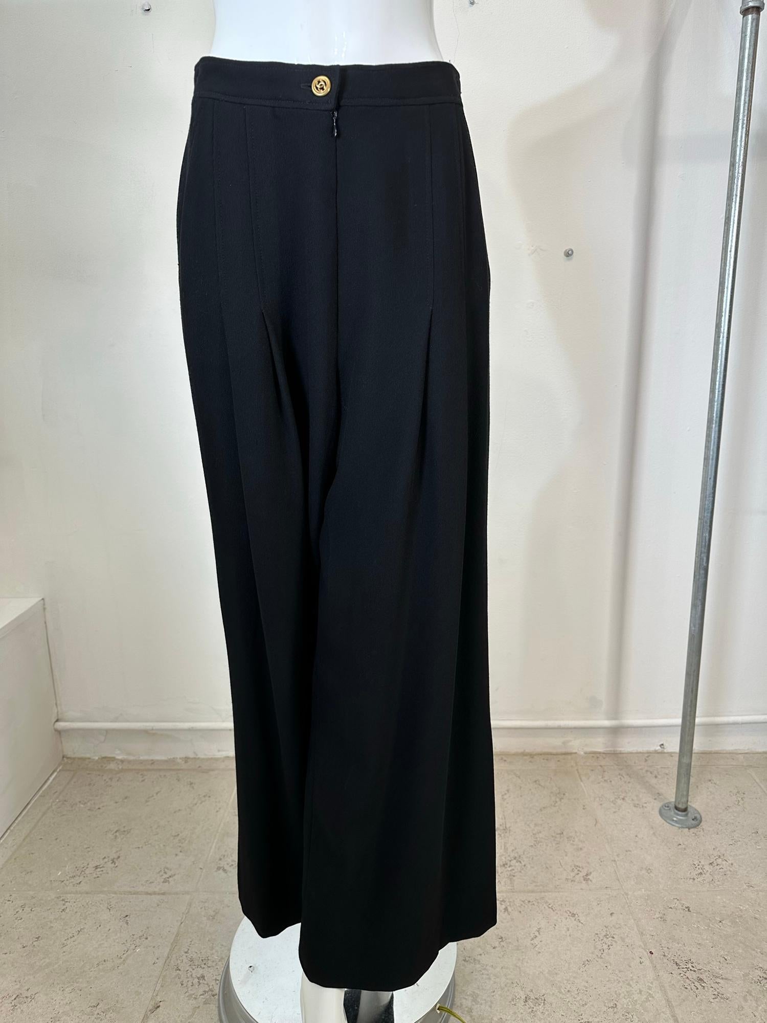 Chanel black wool twill high waist, fly front, gold Chanel logo button at waist band front. Pleated full wide leg trousers from 1995. Beautiful drape, classic 1940s influence man tailoring for women. Fully lined in silk. Fits like a size 6, check