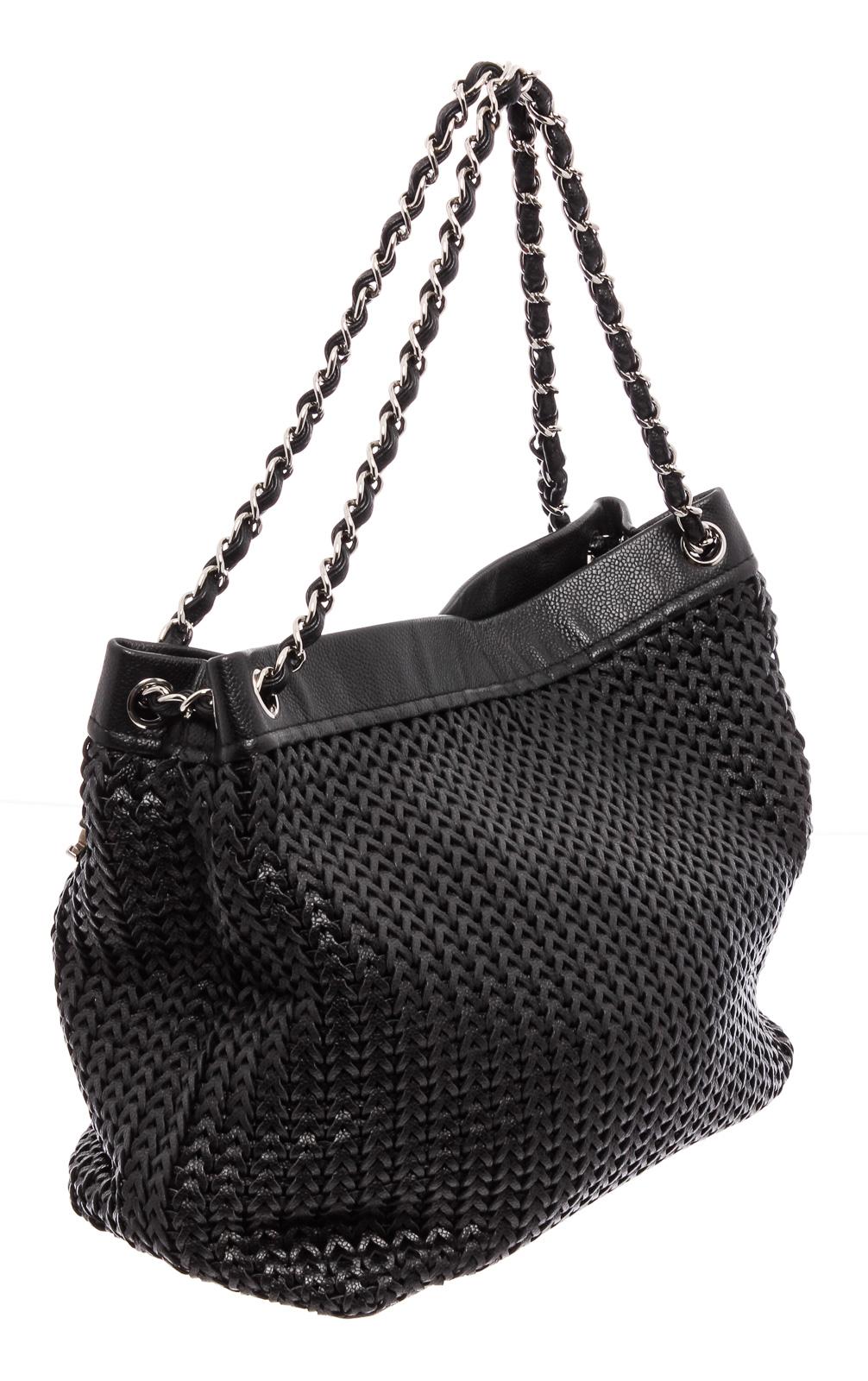 Soft woven leather with twin silver and black leather shoulder straps. Includes a magnetic snap closure and silver CC pendant, as well as a zip pocket inside the black 