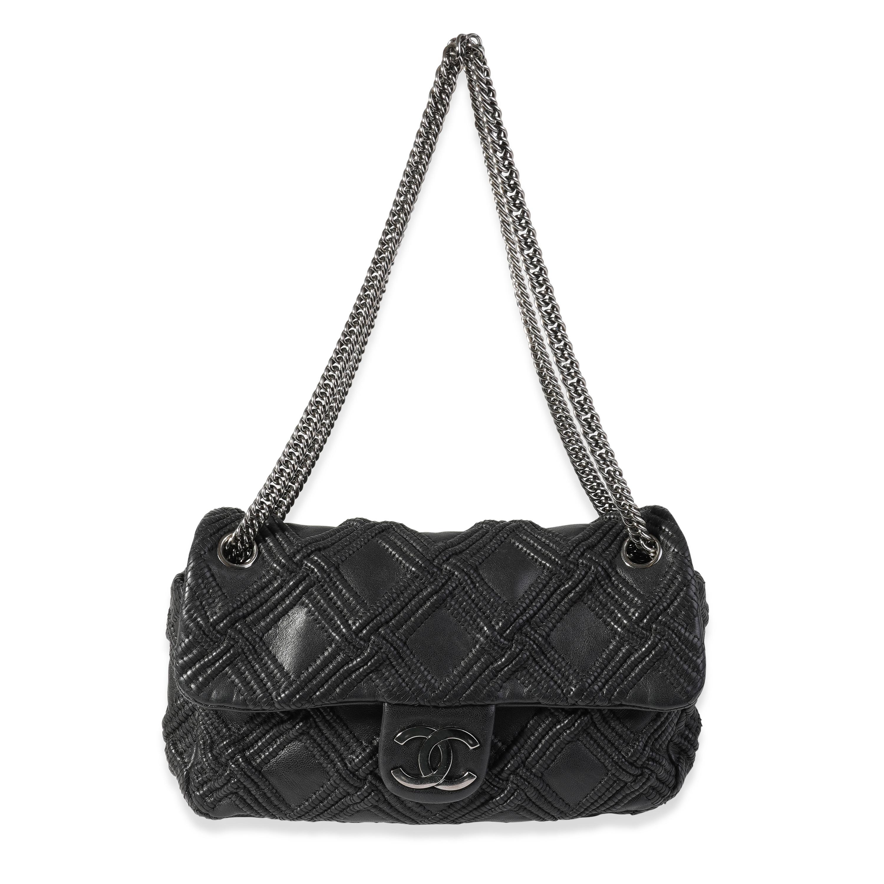 Listing Title: Chanel Black Woven Grid Leather Single Flap Bag
SKU: 121317
Condition: Pre-owned 
Handbag Condition: Very Good
Condition Comments: Very Good Condition. Light scuffing to corners and exterior. Light peeling to base. Scratching to