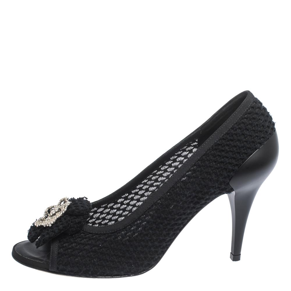 Upgrade your look by adding these Chanel pumps to the wardrobe. They are crafted from woven tweed and designed with signature Camellia motif on the uppers, peep toes and 10 cm heels. These black pumps will be a fine choice with both formal and