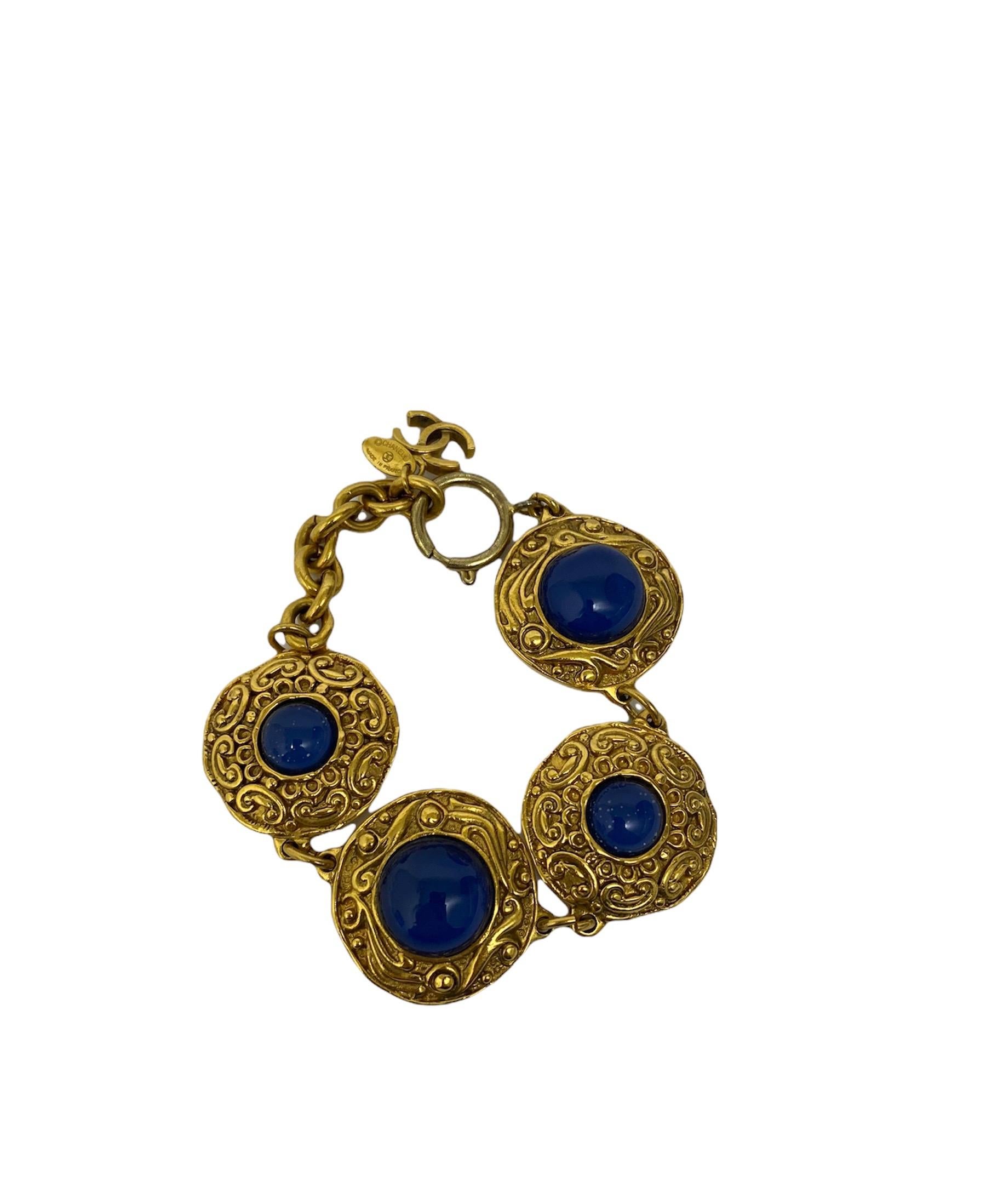 Chanel bracelet in golden hardware with blue crystals.The bracelet is 23.5 cm long. It has a spring ring closure.The conditions of the bracelet are great with slight signs of wear.