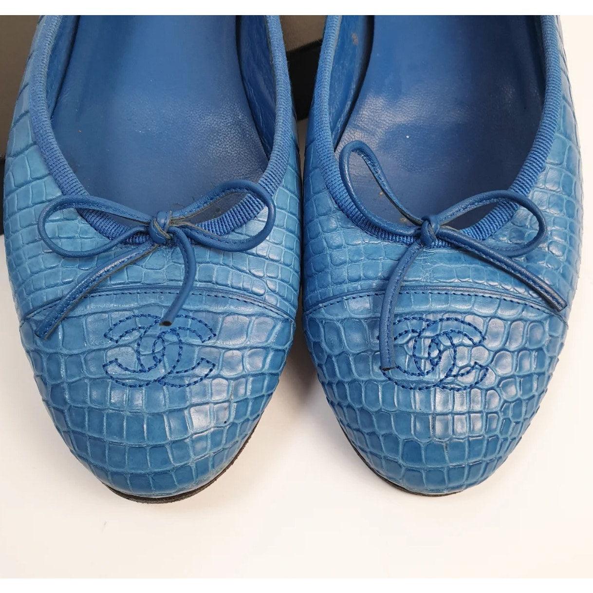 Entra nel lusso con queste splendide ballerine Chanel in alligatore blu! Queste eleganti ballerine presentano l'iconico logo 