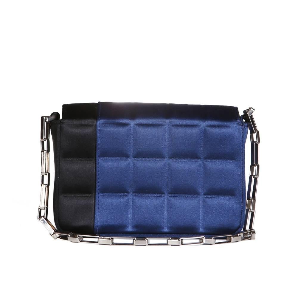 Bag by Chanel from the early 2000s 
Geometric grid-like quilting design
Silver chainlink handle
Black nylon and satin lining
Flap closure with snap
5.5