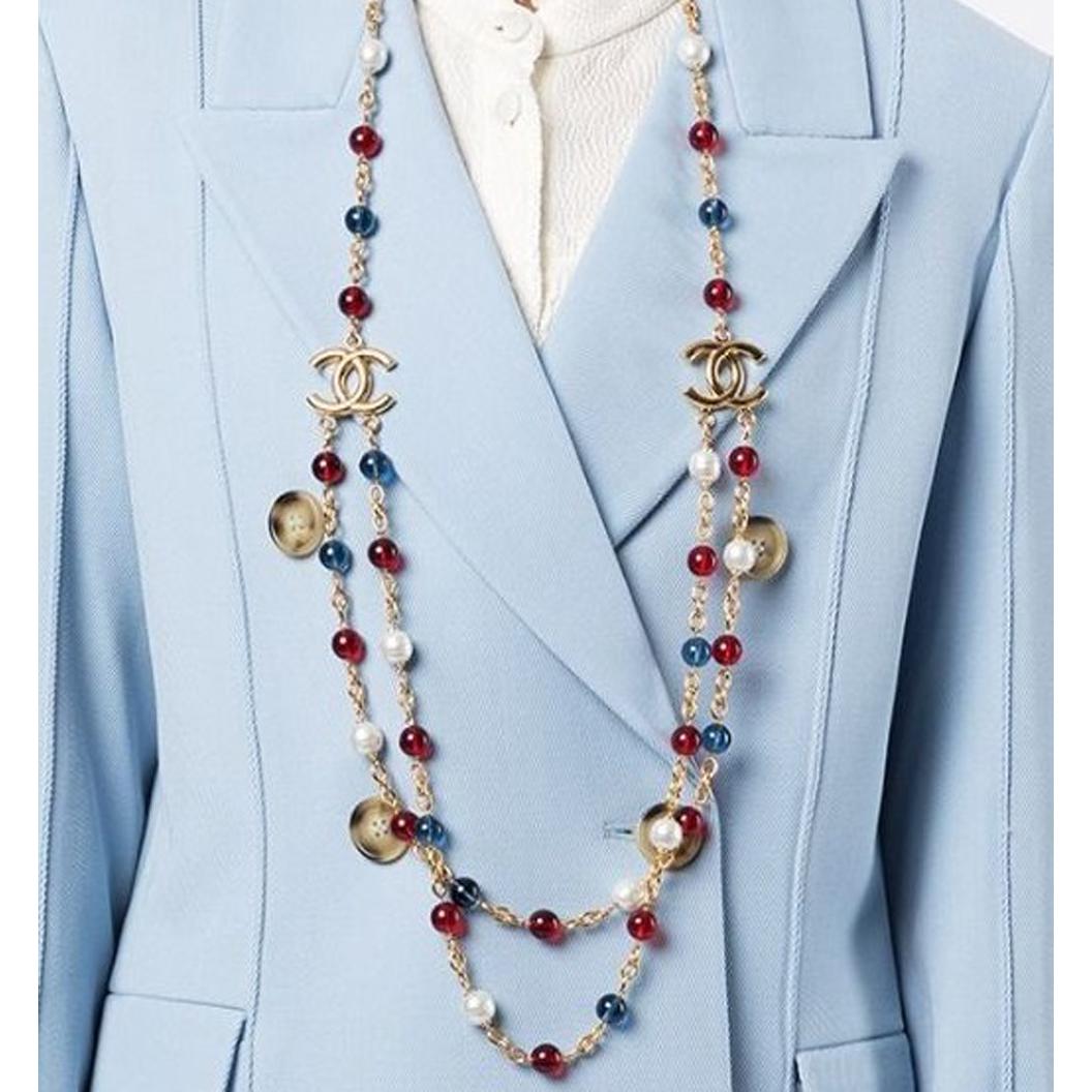 An essential piece for any Chanel lover, this vintage 2007 beaded necklace was crafted in France from gold-plated metal, faux pearls, blue and ruby red glass beads. Embellished with the Maison's signature 'CC' charms, this unique piece will never go