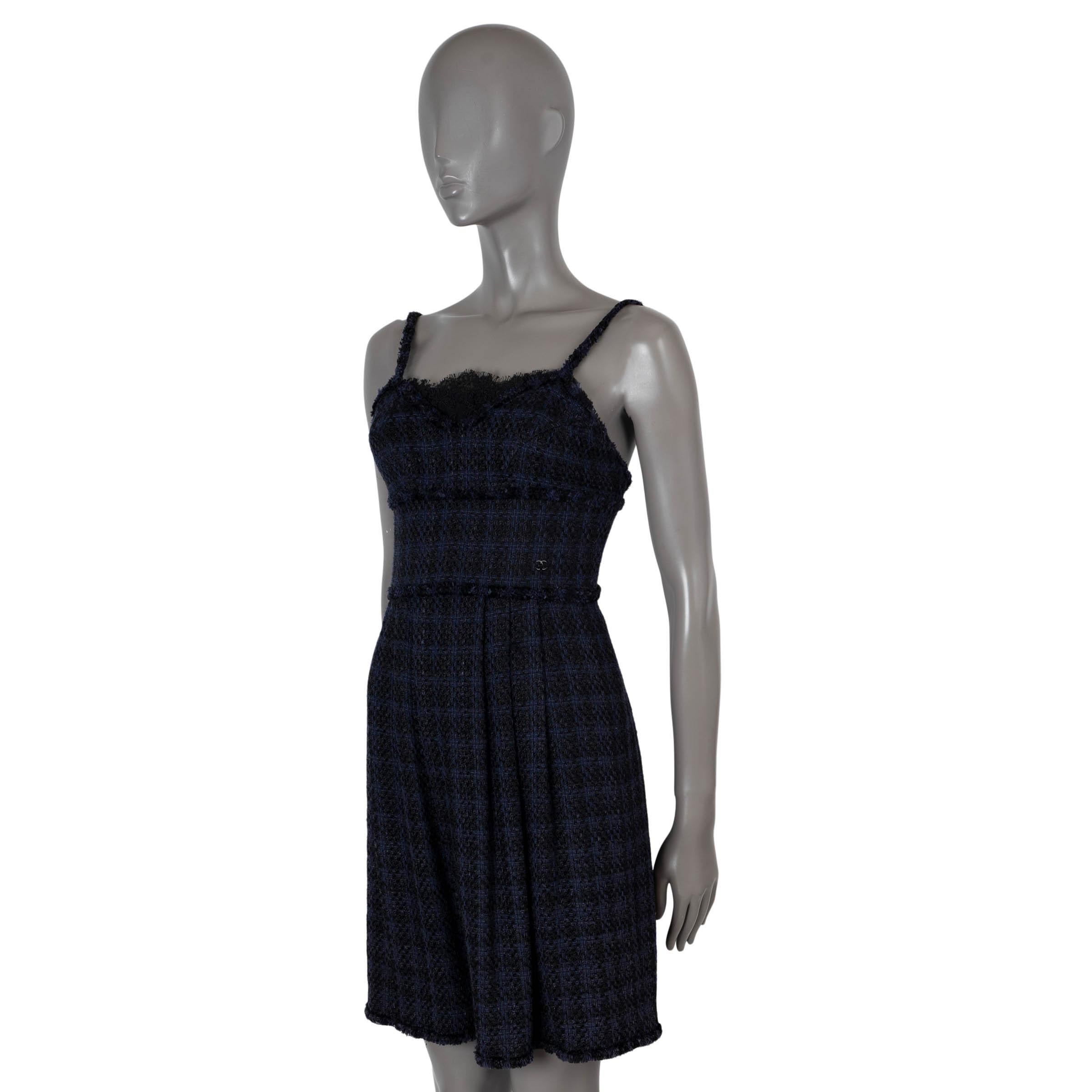 100% authentic Chanel A-Line dress in navy and black viscose (42%), linen (35%) and cotton (23%). Features frayed edges on the shoulder straps, neckline and hem. Closes with black concealed zipper and a hook. Lined in blue silk (100%). Has been worn