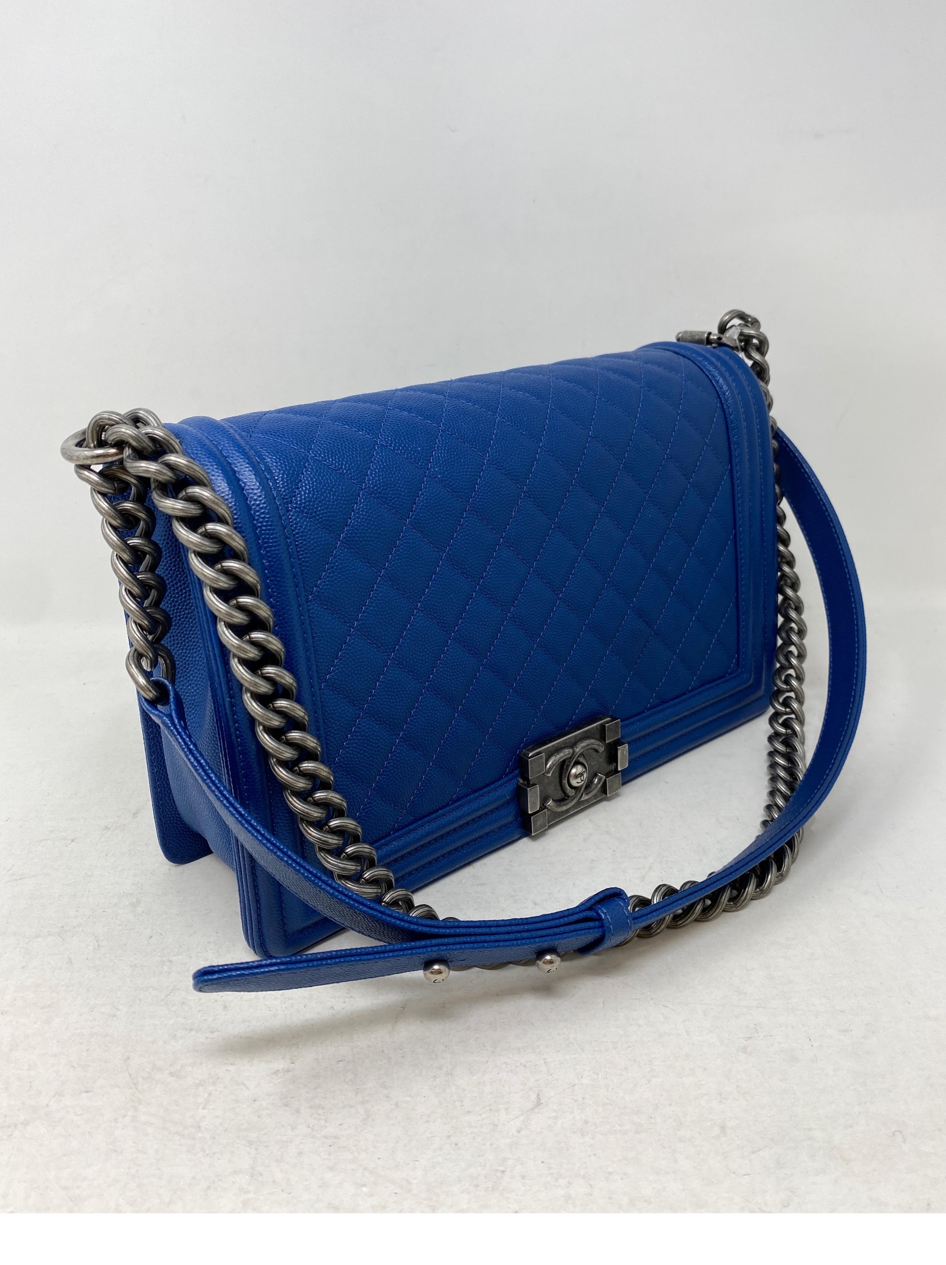 Chanel Blue Boy Bag. Gorgeous caviar blue leather. Ruthenium hardware. Mint like new condition. Rare color blue Boy bag. Can be worn as a crossbody or doubled as a shoulder bag. Guaranteed authentic. 