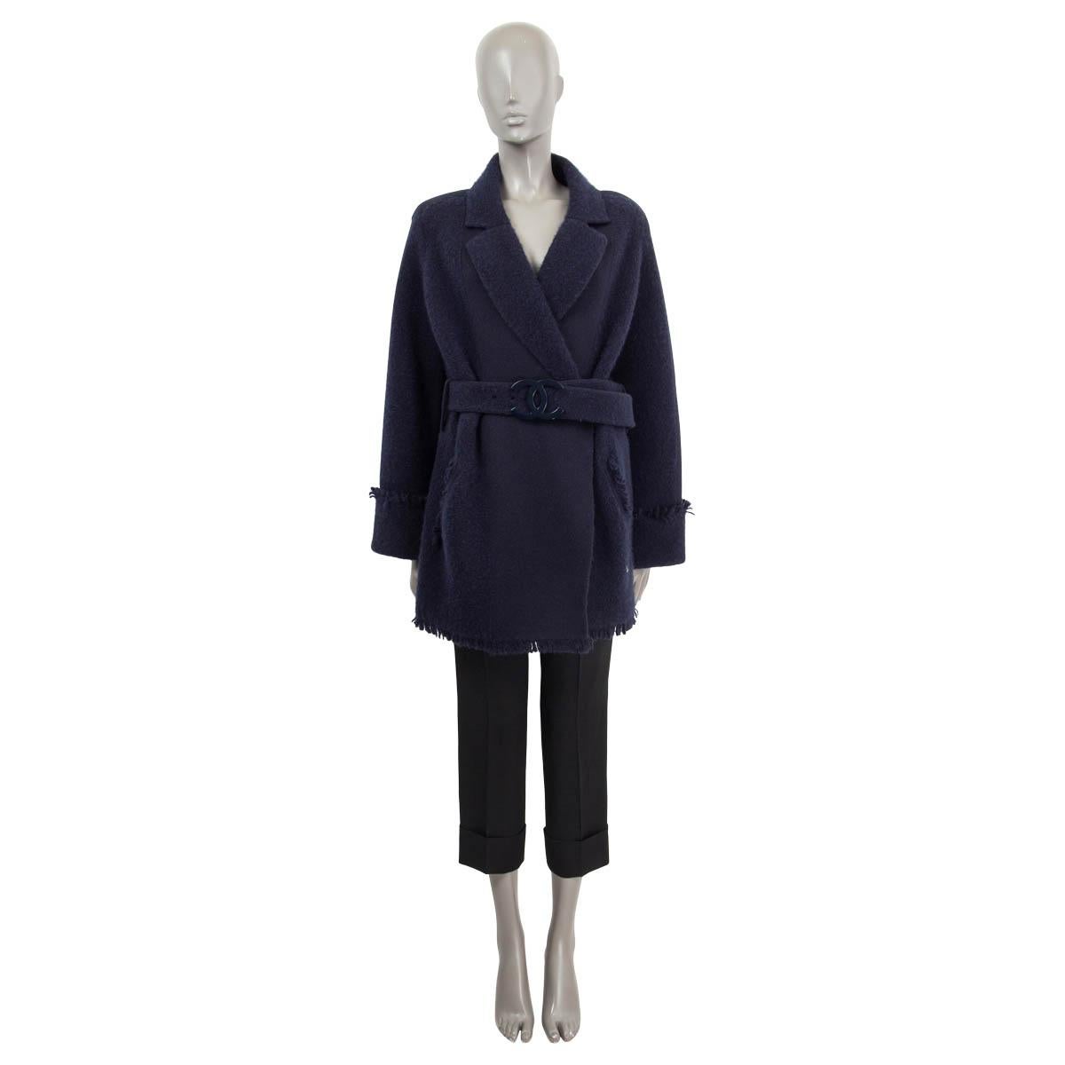 100% authentic Chanel belted oversized knit coat in navy cashmere (88%), polypropylene (6%) and silk (6%). Features long raglan sleeves (sleeve measurements taken from the neck), two slit pockets and fringed details. Has a matching detachable 'CC'