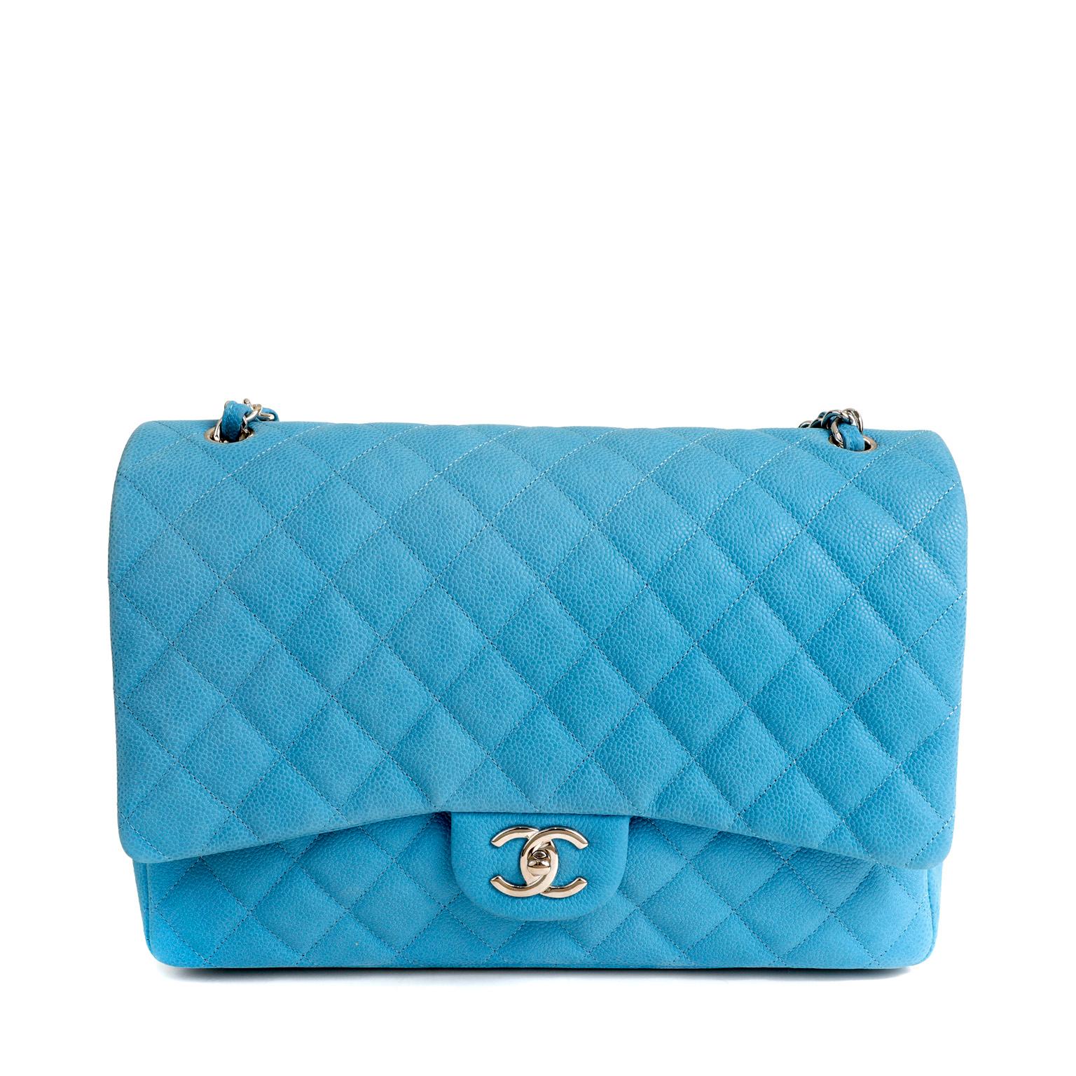 This authentic Chanel Blue Caviar Maxi is in pristine condition.  Showstopping bright blue paired with silver hardware is a stunning combination.  
Vibrant brushed caviar leather is textured and durable.  Quilted in signature Chanel diamond pattern
