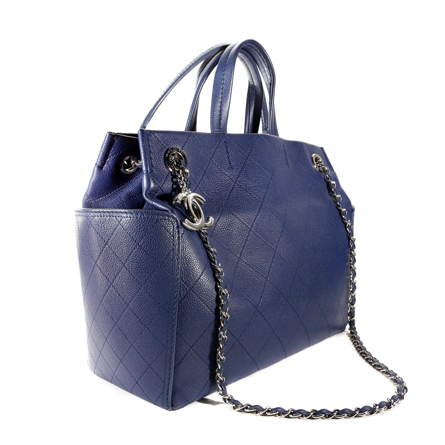  Chanel Blue Caviar Tote -  pristine condition
Carried by the short handles or the long chain, it is a versatile piece perfect for daily enjoyment. 
Marine blue caviar leather is textured and durable.  Signature Chanel diamond stitched pattern with