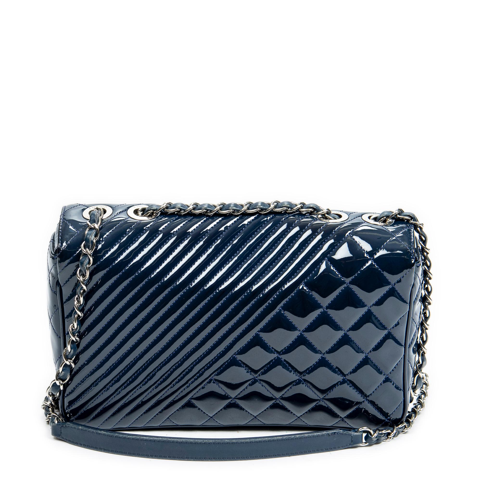 Meet the Chanel Blue CC Medium Coco Boy Flap: a statement of sophistication. Crafted from quilted patent leather in a captivating blue hue, this bag exudes elegance. Adorned with gleaming gold hardware, including the iconic CC turnlock closure, it