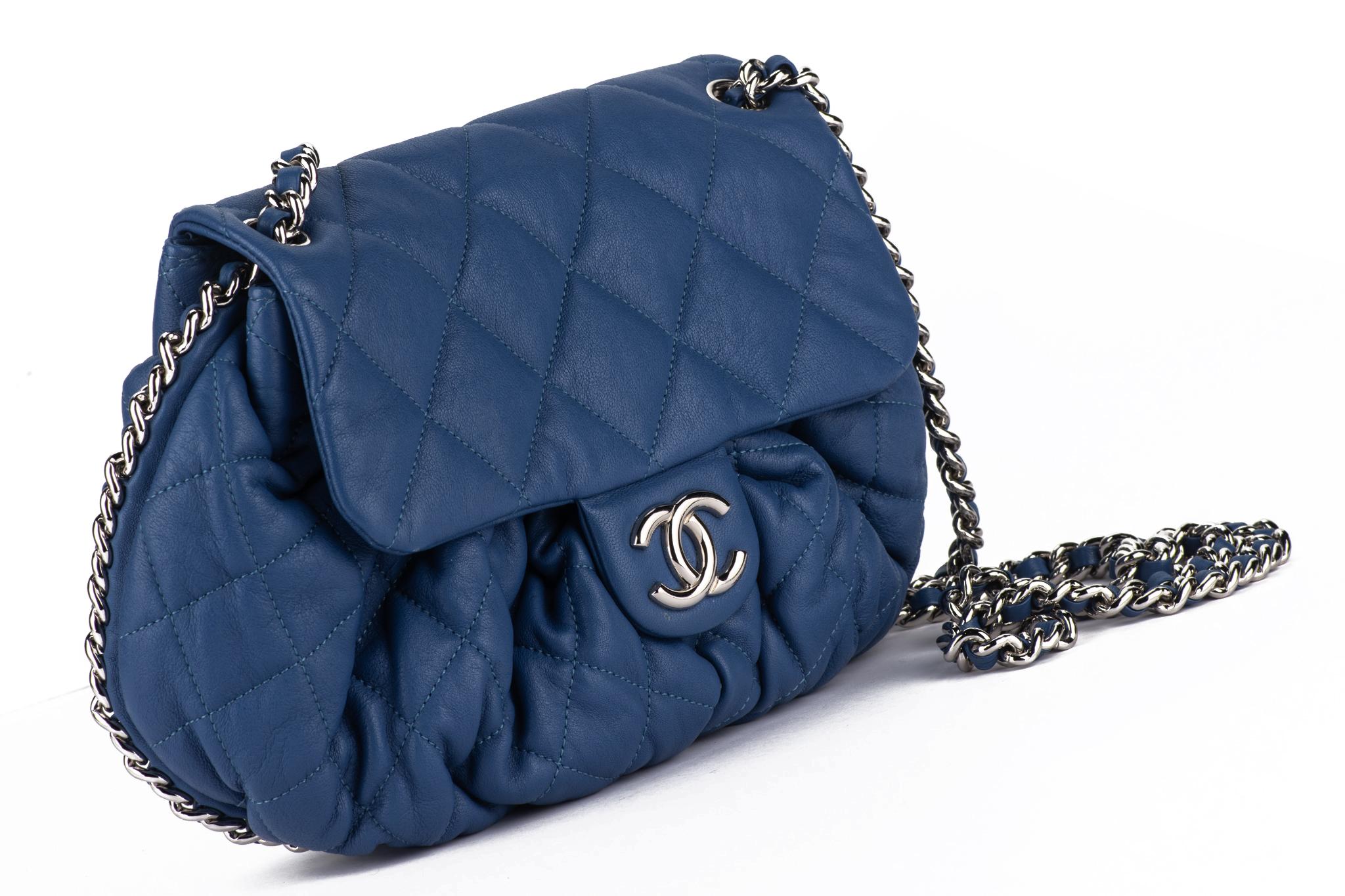 Chanel Blue Lambskin Chain Around Shoulder Bag of quilted lambskin with silver toned hardware. The bag features the woven leather and chain shoulder strap 
The flap closure opens via the CC logo with one interior zipper pocket.
Collection