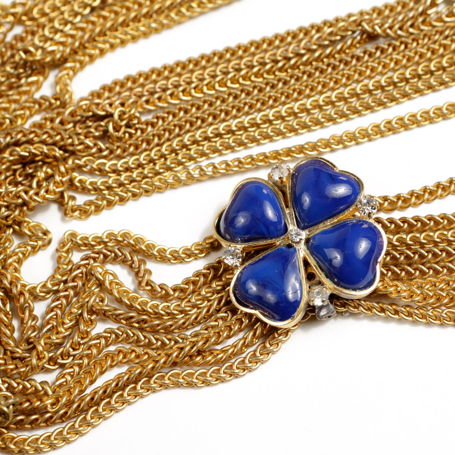 This authentic Chanel Blue Clover Gold Multi Chain Necklace is in beautiful condition.  An early vintage piece, it is considered highly collectible.  Eight gold link chains are anchored by a large royal blue enamel four leaf clover.  Edged in gold