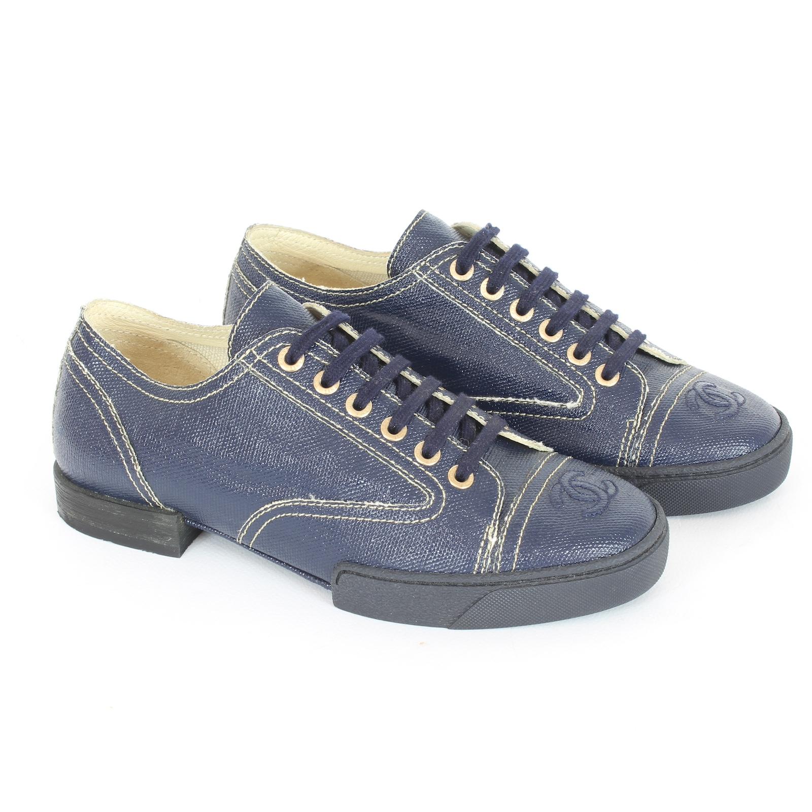 Step up your sneaker game with the Chanel Blue Coated Toile Lace Up Sneakers. Made of luxurious coated fabric, these sneakers feature a signature embroidered logo and branded eyelets. The rubber sole provides durability and comfort. Elevate your