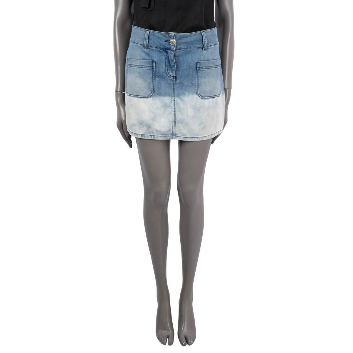100% authentic Chanel mini denim skirt in blue cotton (60%), viscose (38%) and elastane (2%). Features a white acid washed lower half and two patch pockets on the front. Opens with a jewelled button. Unlined. Has been worn and is in excellent