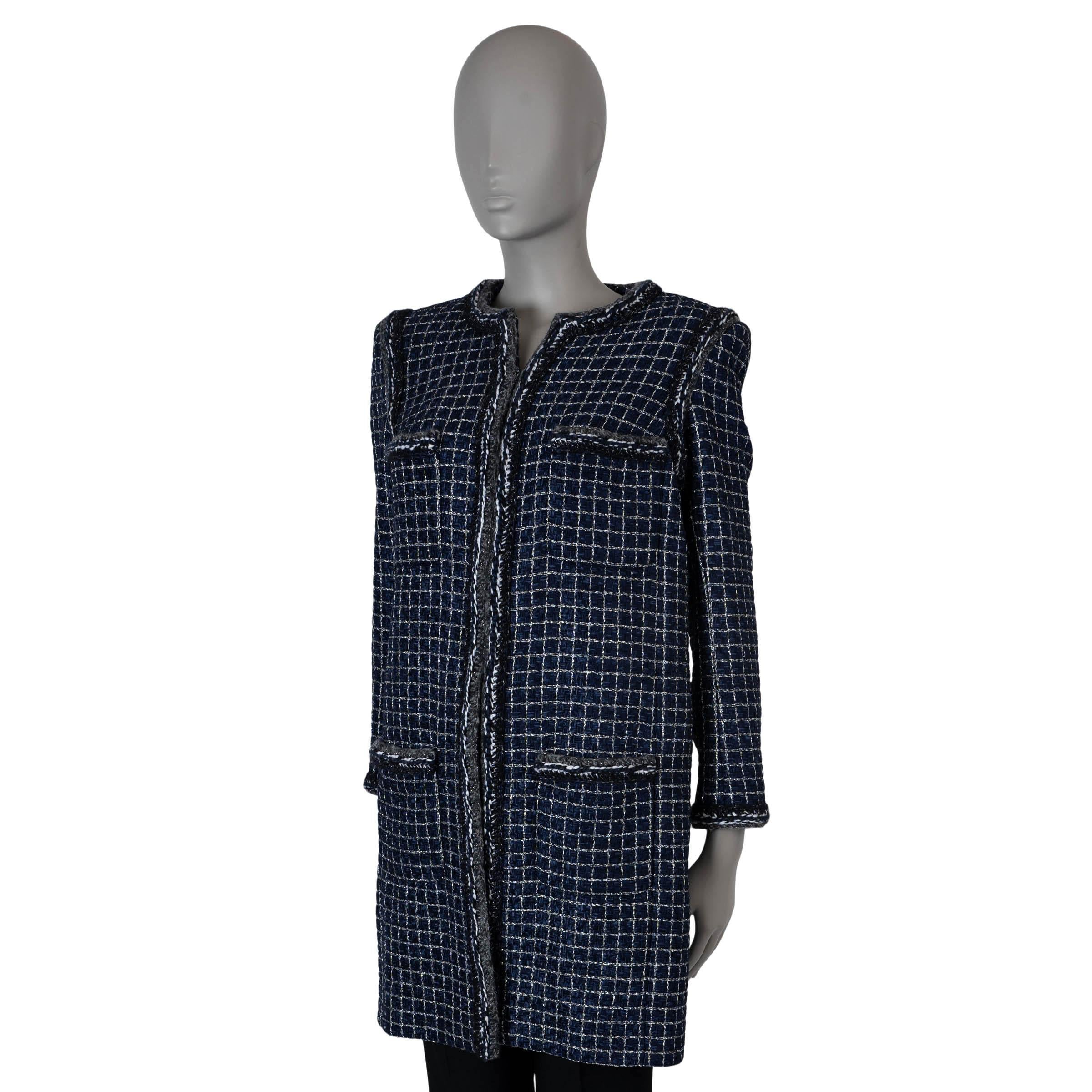 This 100% authentic Chanel lurex chunky tweed coat is crafted from a blend of navy blue polyamide (82%), cotton (16%), acetate (1%), and polyester (1%), featuring a white, metallic silver and black grid pattern. The coat has a collarless, straight