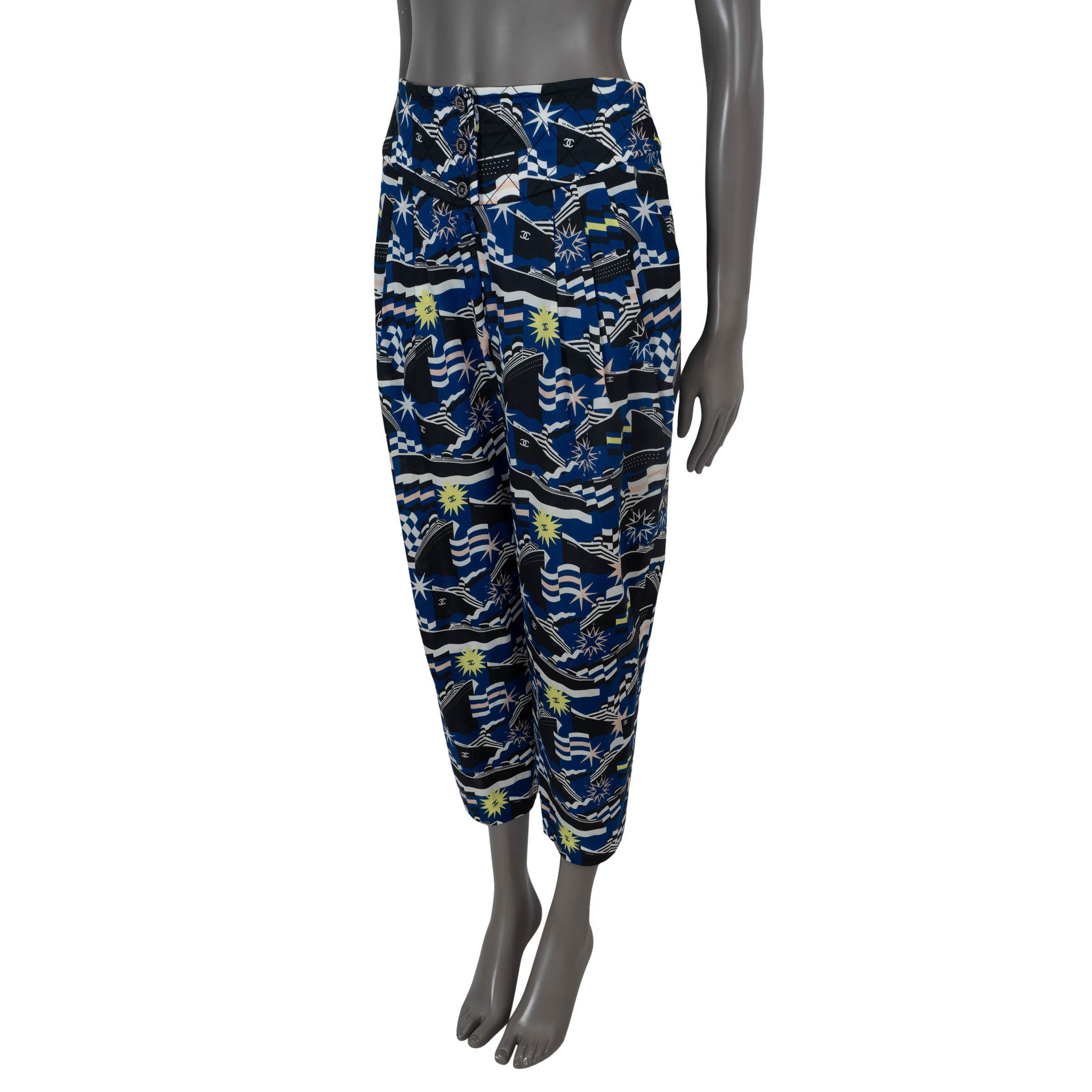 100% authentic Chanel printed pants in blue, navy, white, yellow and soft pink poplin cotton (100%). Feature a pleated front, two slit pockets and a quilted waist band. Close with three CC buttons at the waist and are lined in silk (100%). Have been