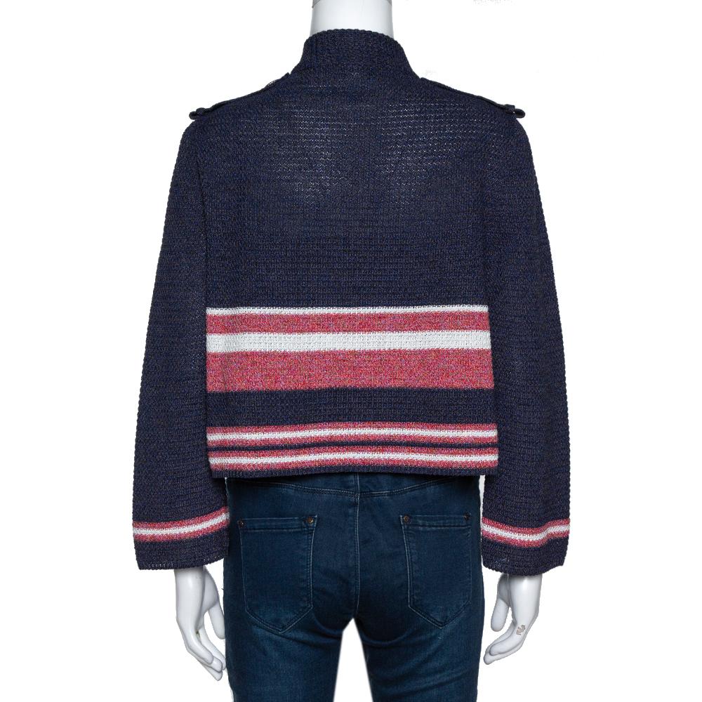 This stylish Chanel cardigan exudes timeless aesthetic, quality craftsmanship, and effortless style. Crafted from a cotton blend, it comes in a lovely shade of blue. The exterior carries a striped pattern that adds interest. It has an open front,