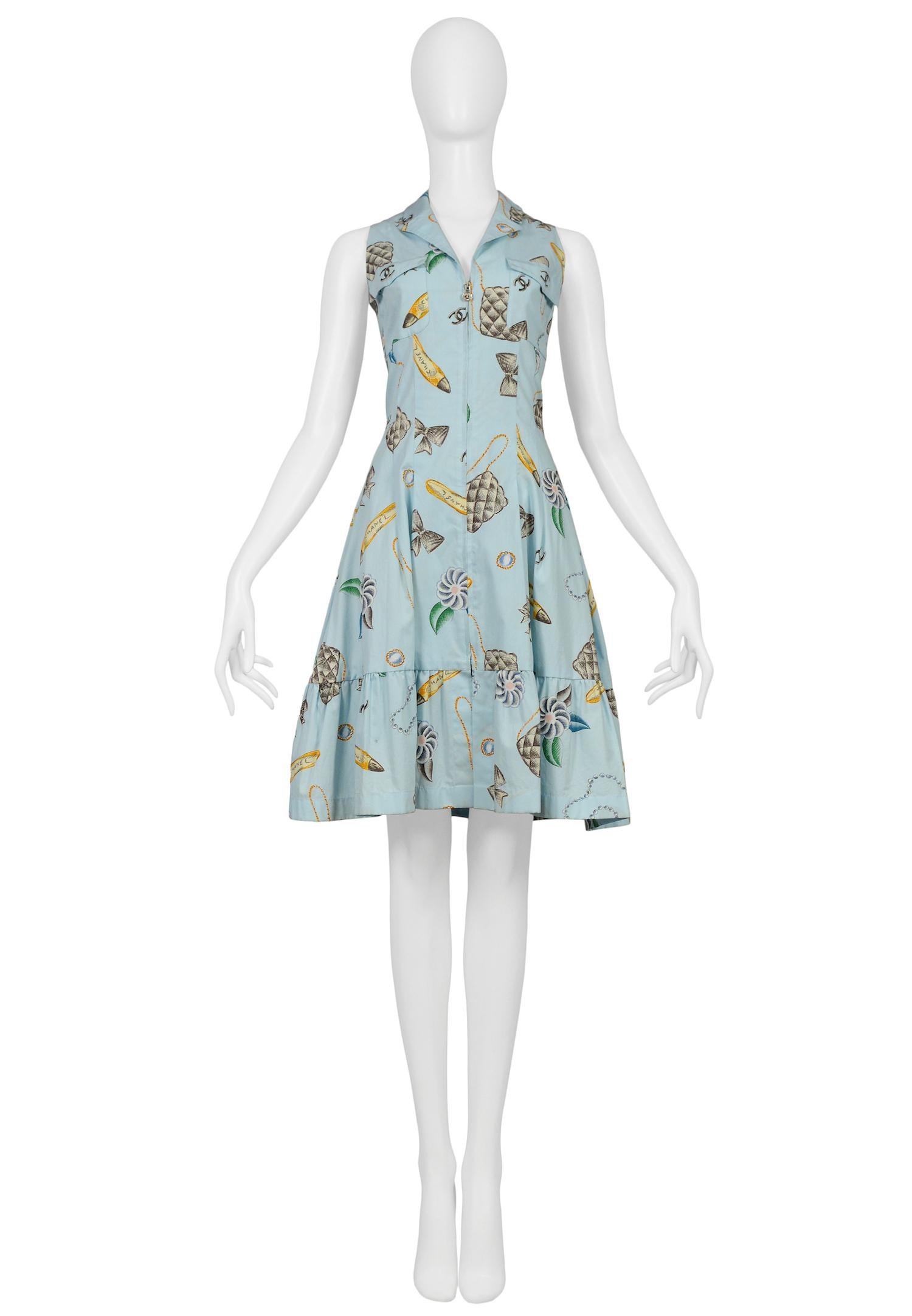 Vintage Chanel blue cotton sleeveless shirt dress featuring chest pockets, a front zipper closure, a flounce at the hem and an allover floral bag, bow, and shoe print. Collection 1996.

Excellent Vintage Condition.

Size 38

Measurements:
Bust