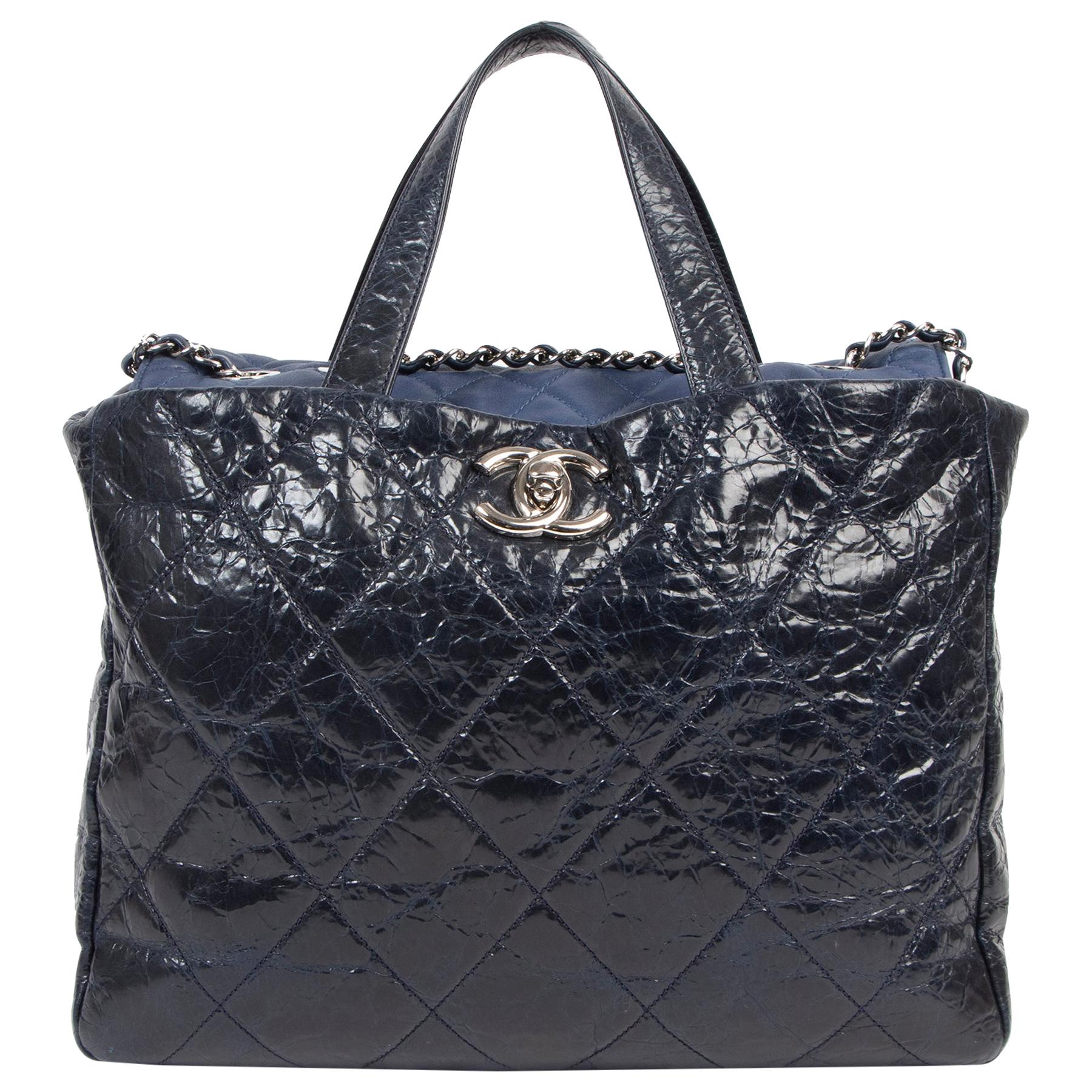 Turn the monday blues into something fabulous with this gorgeous Chanel tote. This beautiful bag comes in navy and  is crafted from distressed leather and lambskin leather. It has a very spacious interior with different side pockets and a zipper